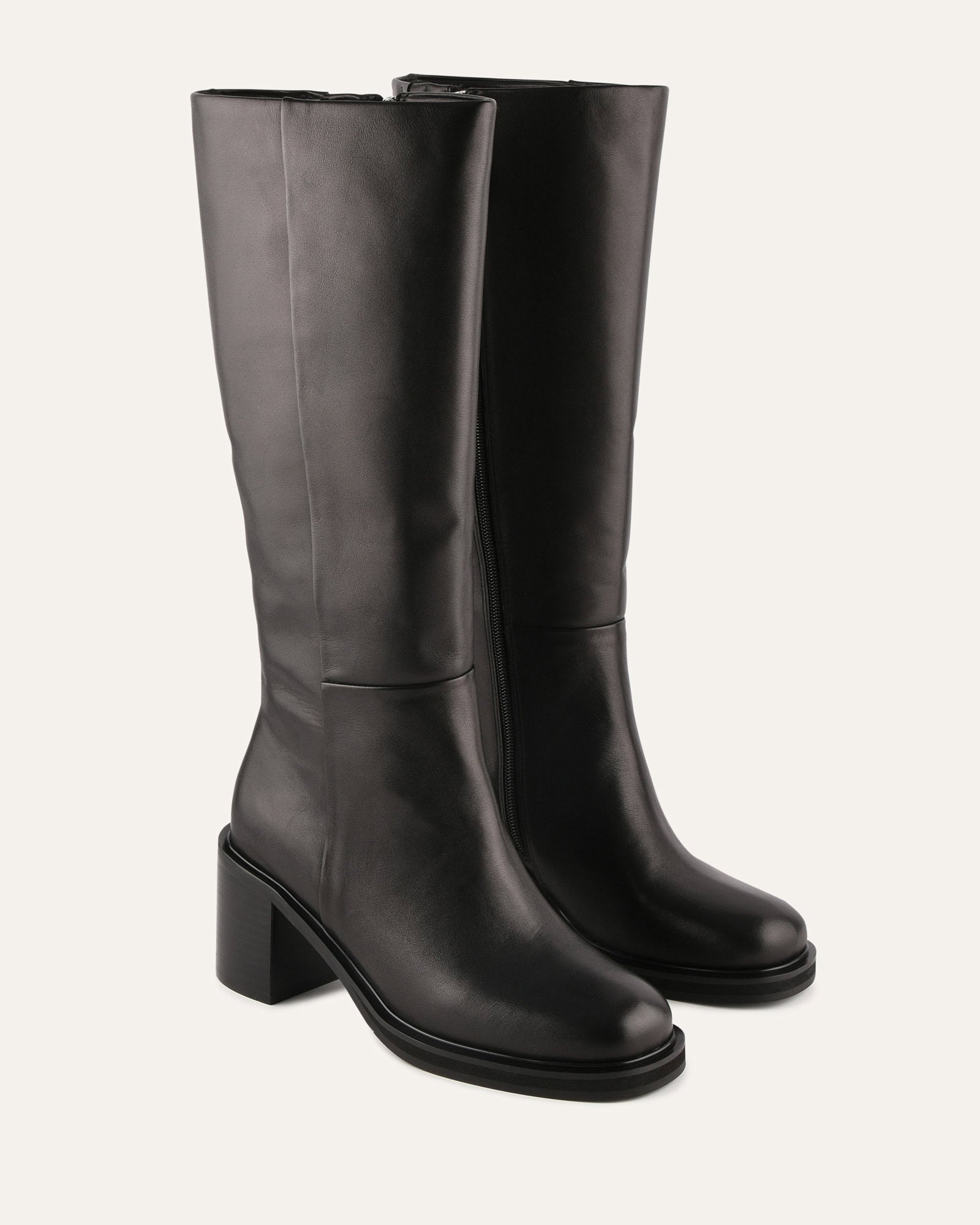 Black knee-high boot on a light gray background
