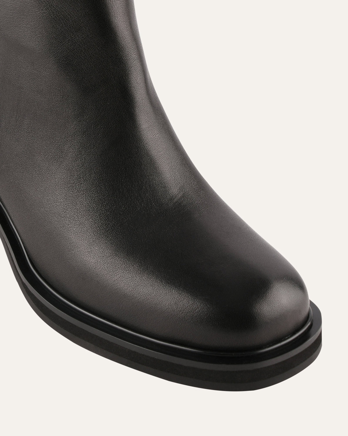 Black leather boot on a white background