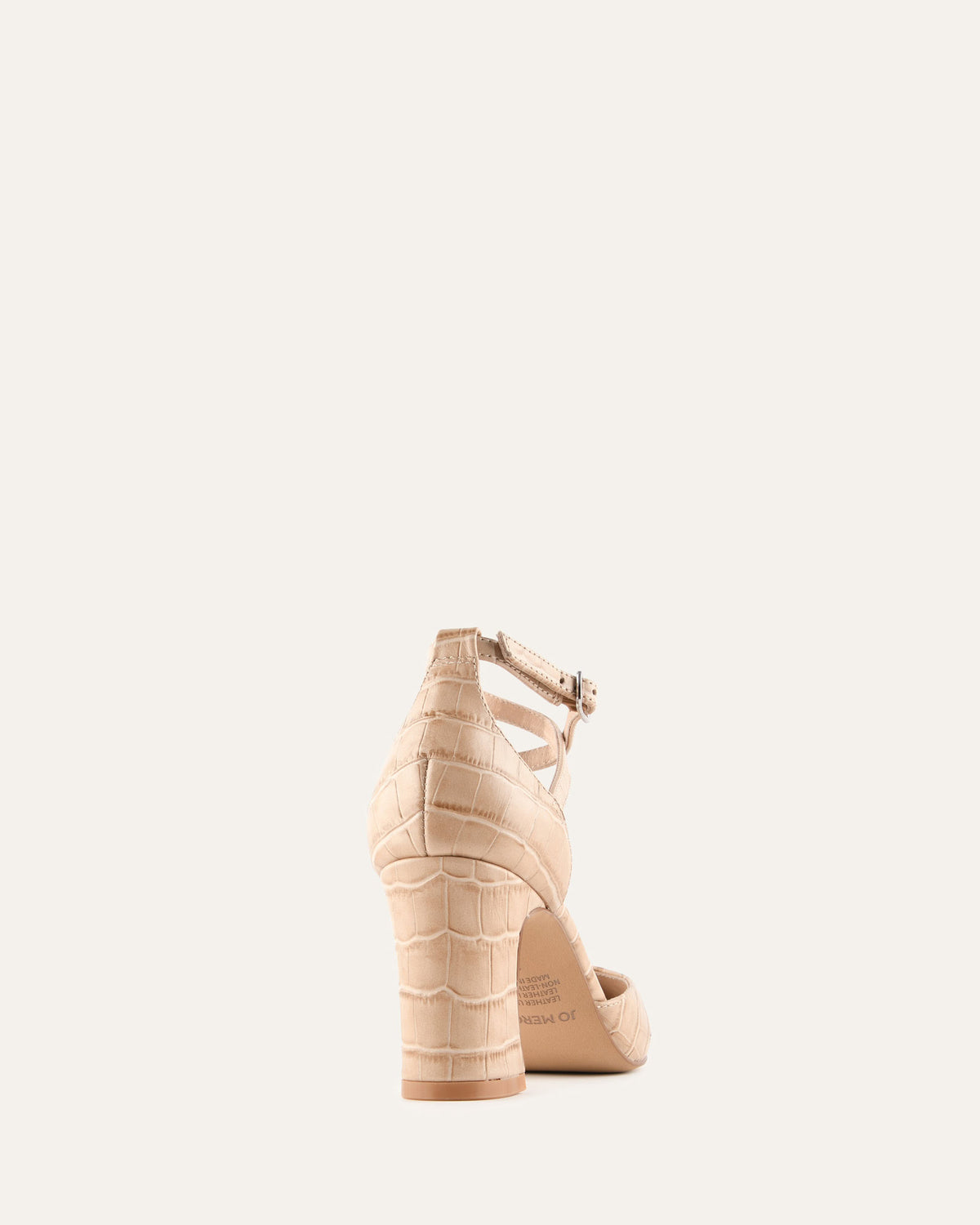 Beige high-heeled shoe on a light beige background