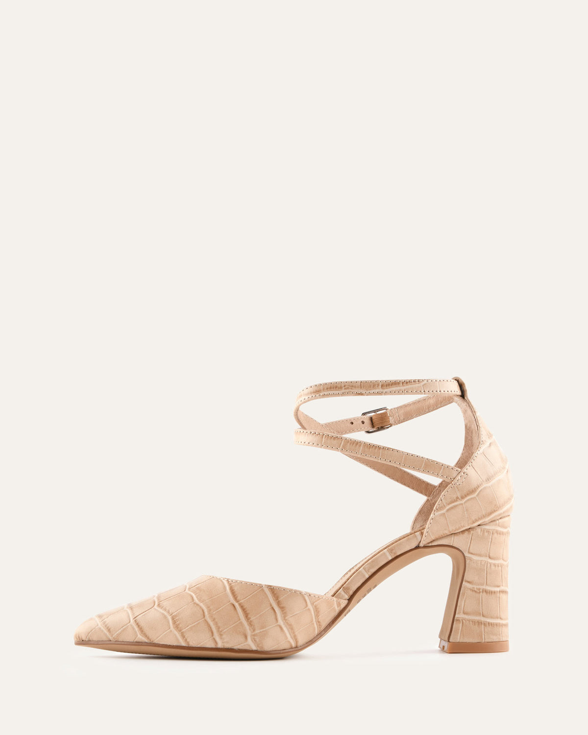 Beige high-heeled shoe with a strap on a light gray background