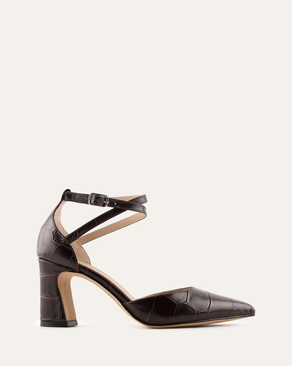 Black high-heeled shoe with a crocodile texture on a white background