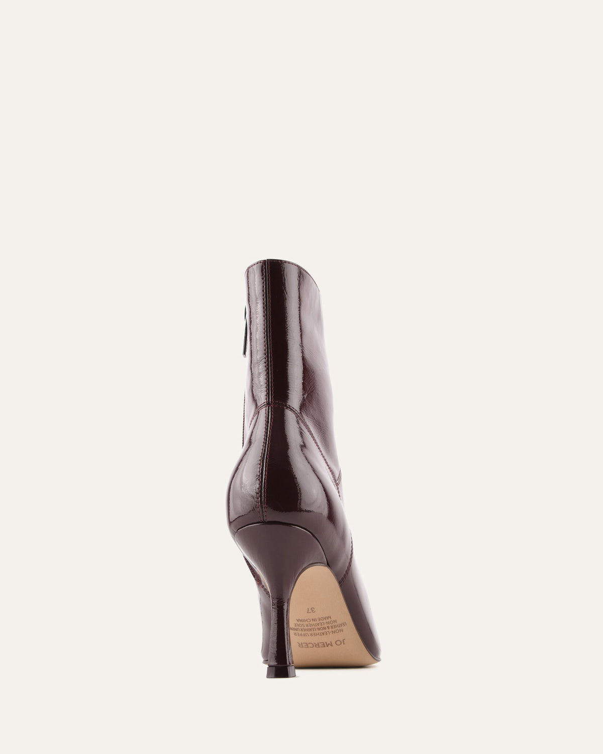 Brown high-heeled shoe on a light beige background