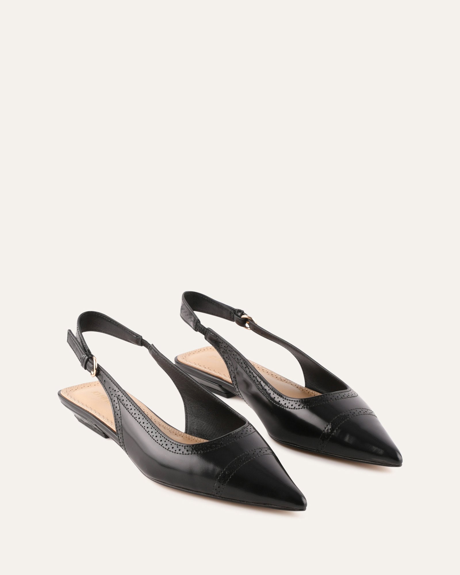 Black slingback flat shoe on a white background