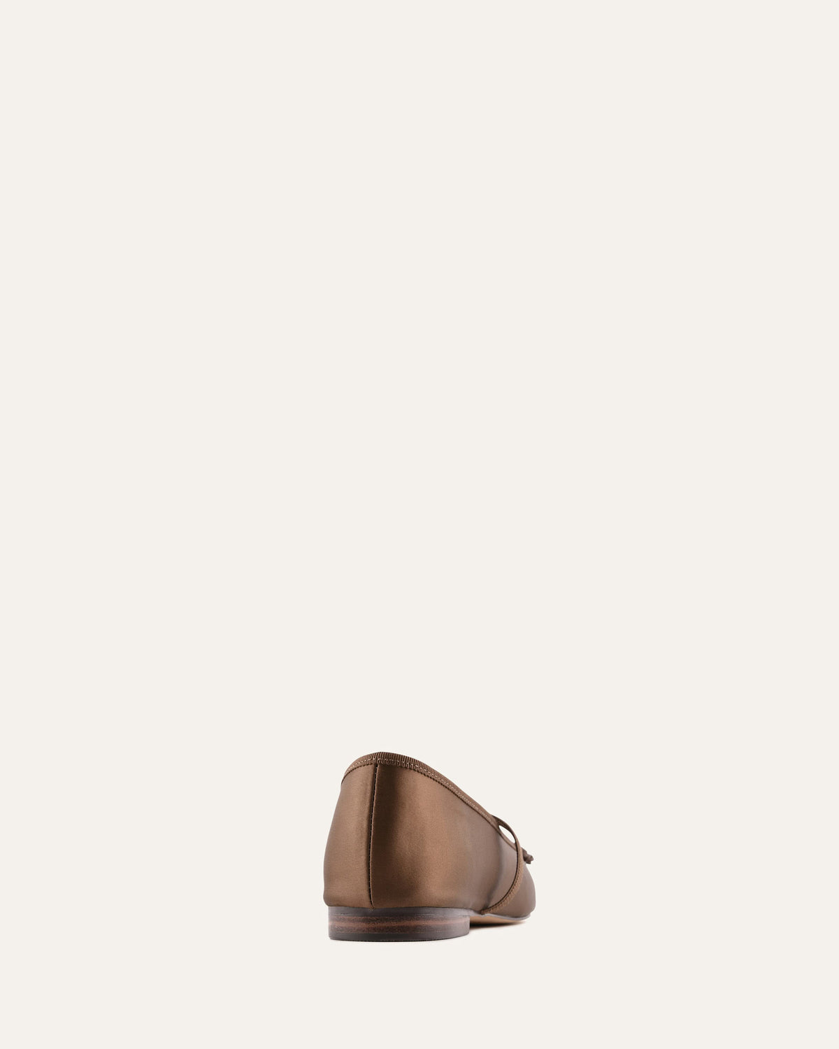 Brown leather shoe on a light beige background