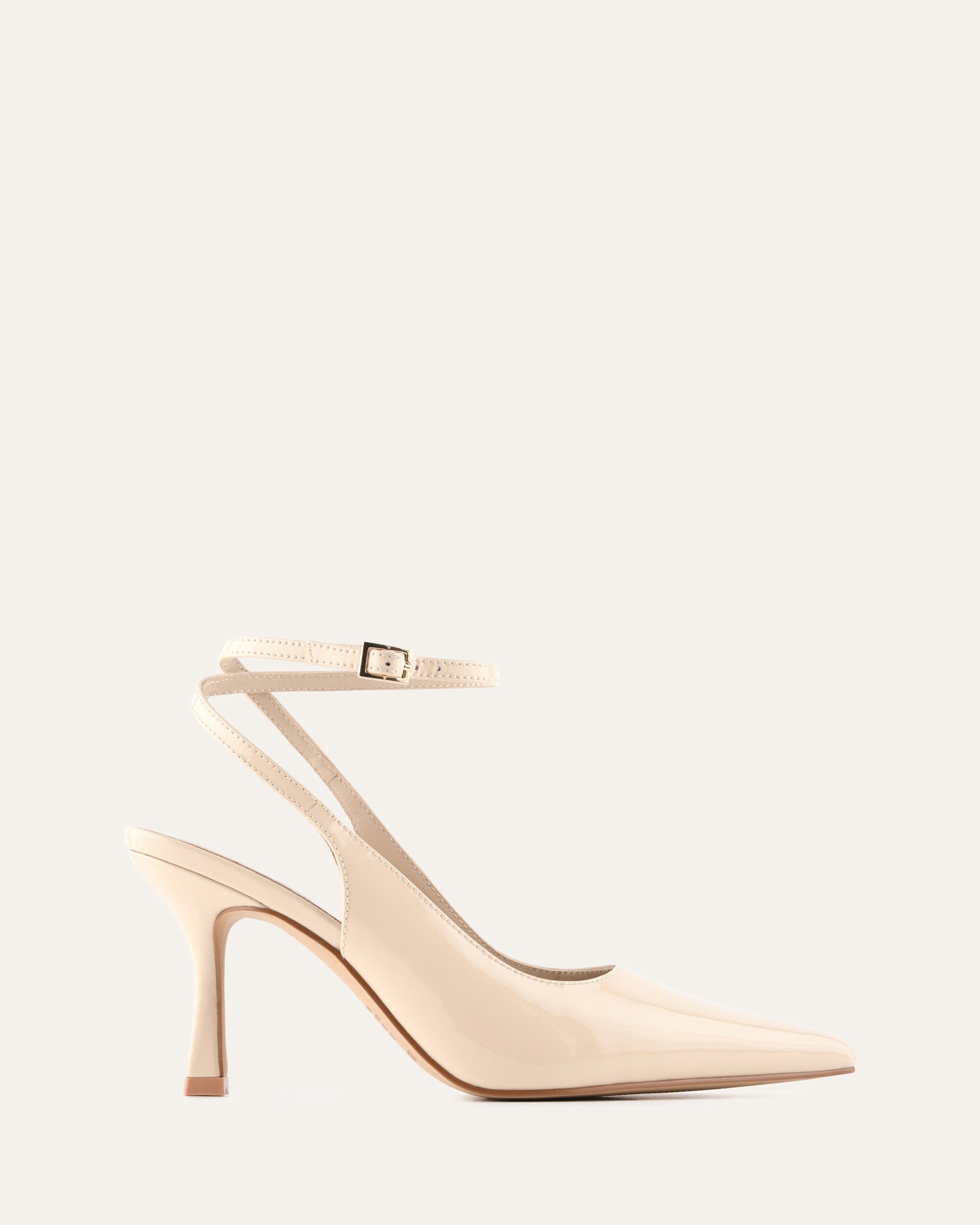 Beige high-heeled shoes on a light beige background