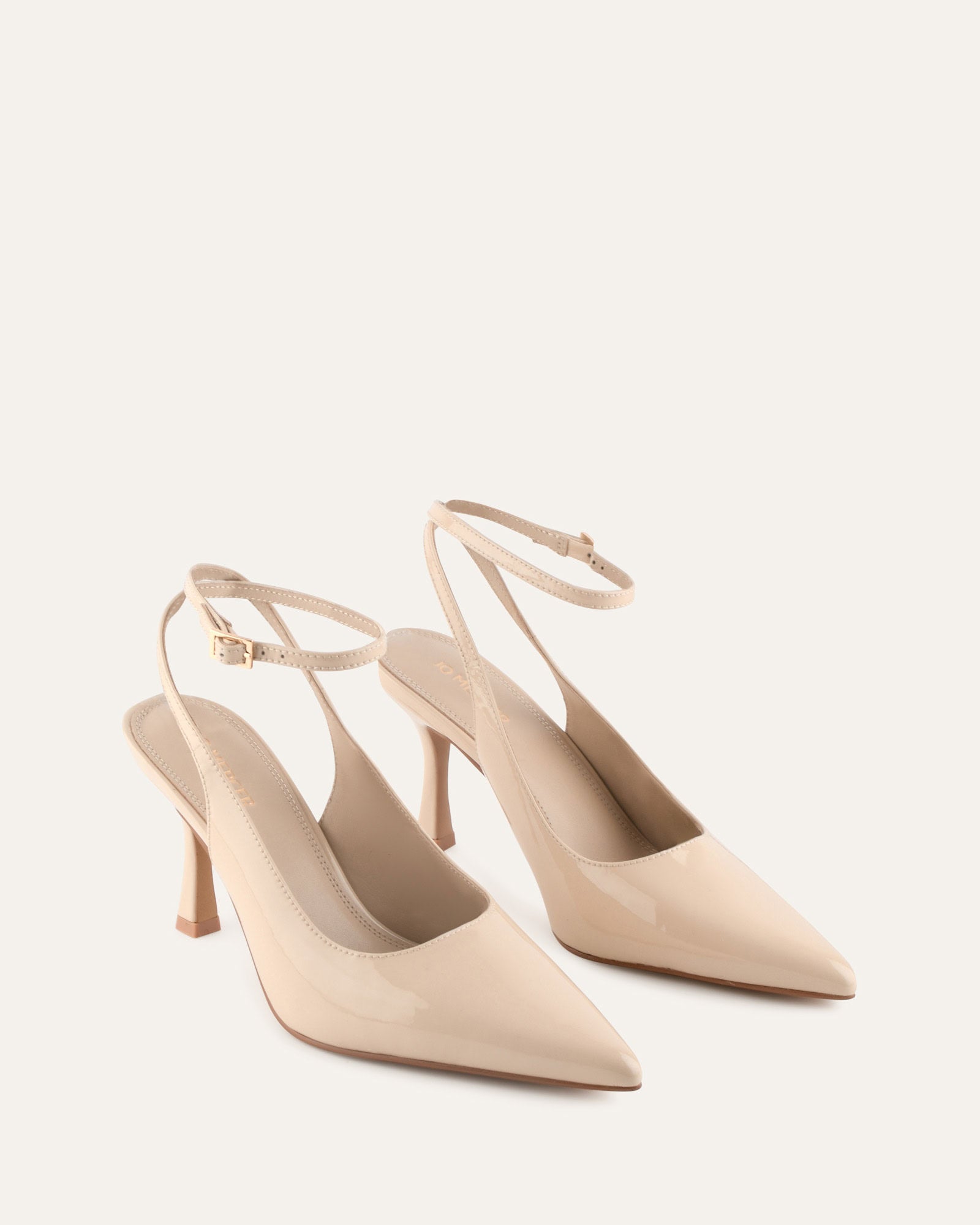 Beige high-heeled shoes on a light beige background