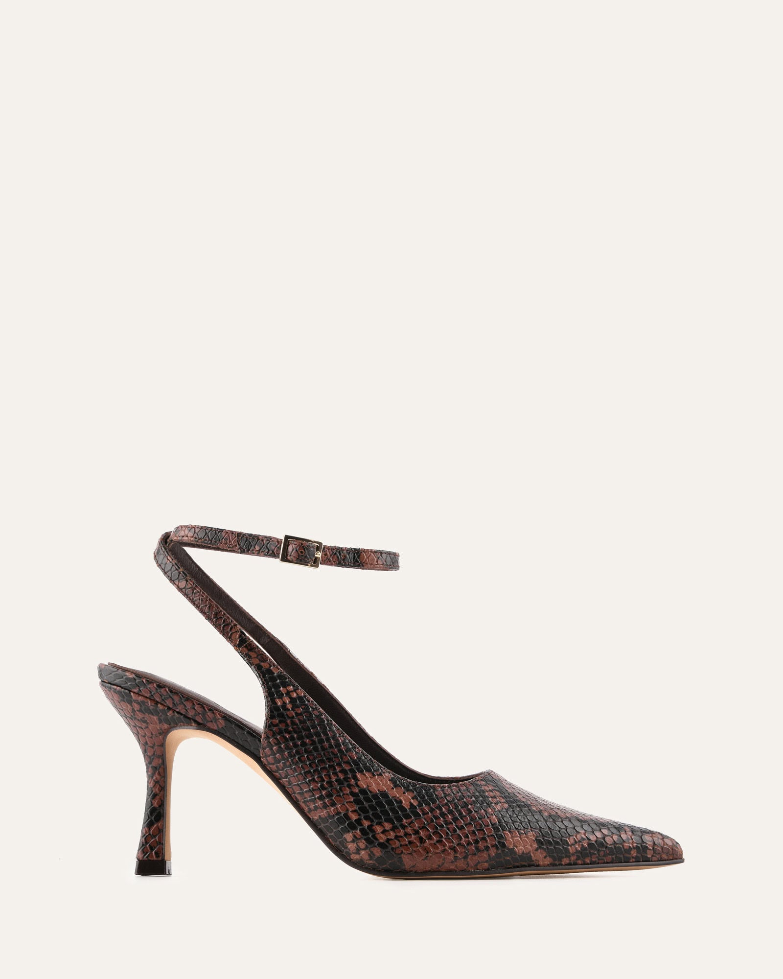 Brown high-heeled shoe with a slingback design on a light gray background