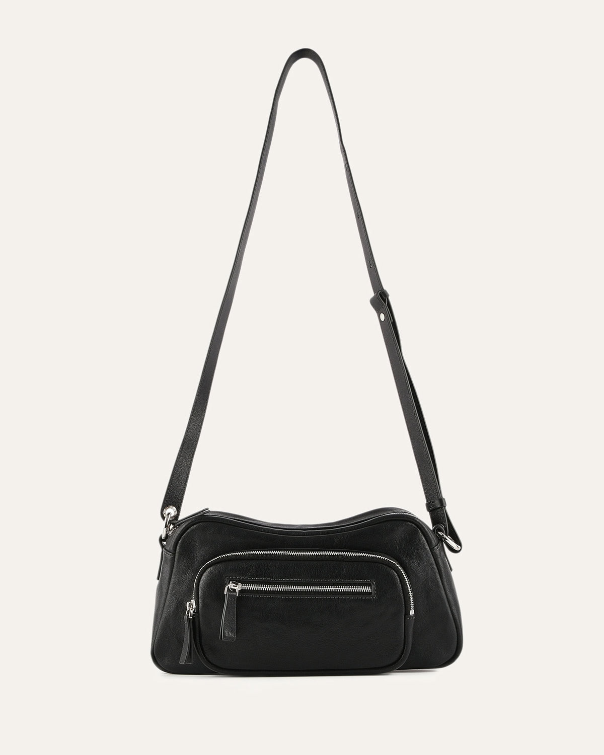 Black handbag with a strap on a light gray background