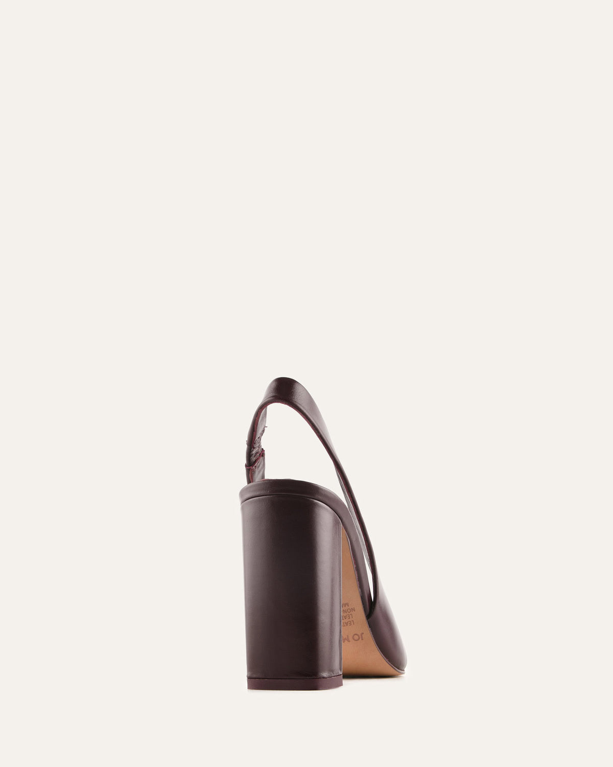 Brown high-heeled shoe on a light beige background