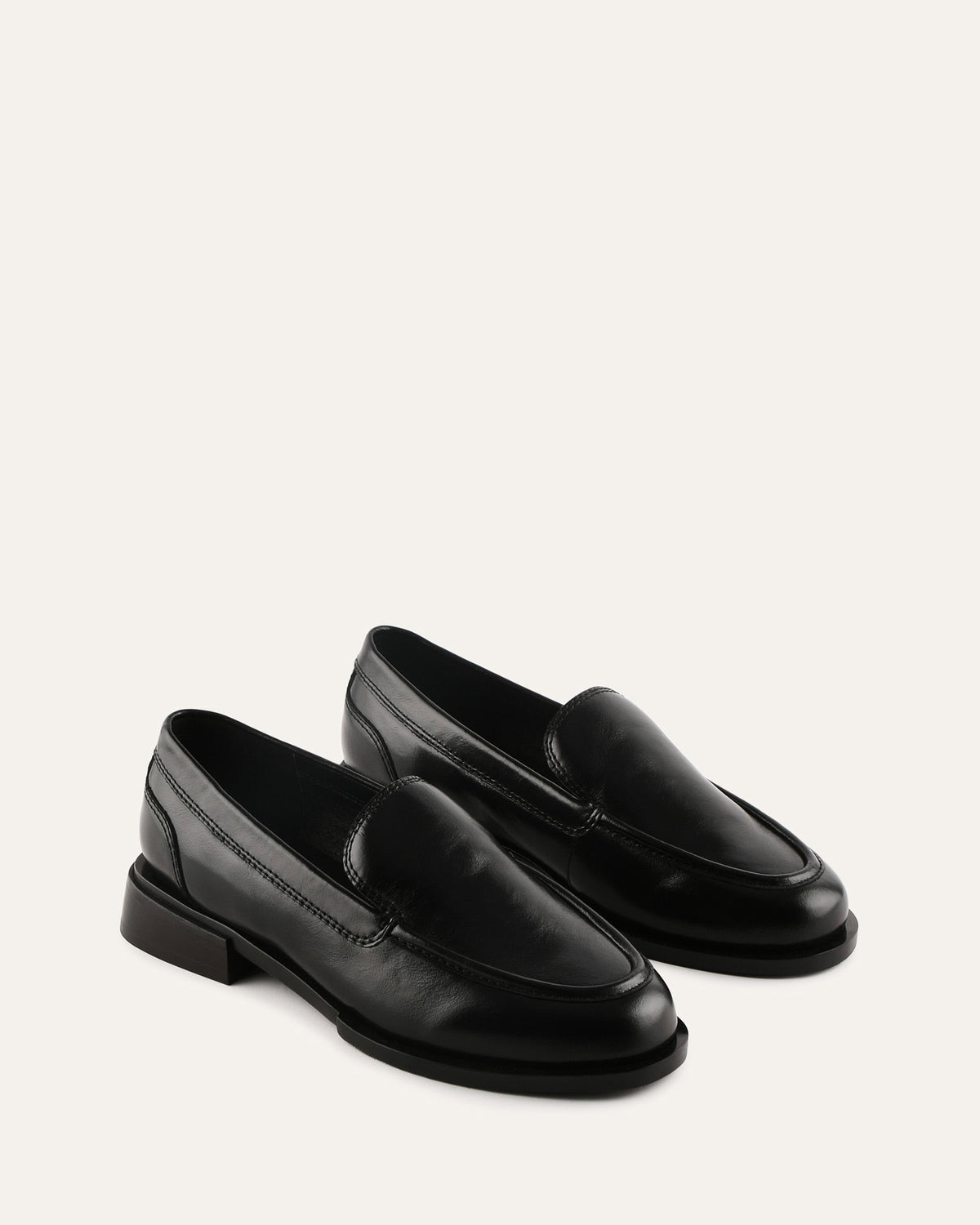 Pair of black loafers on a white background