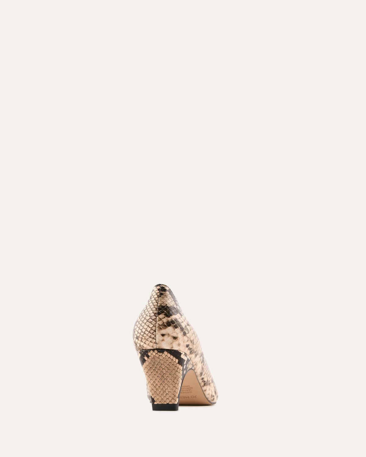 High-heeled shoe with snake print on a light beige background