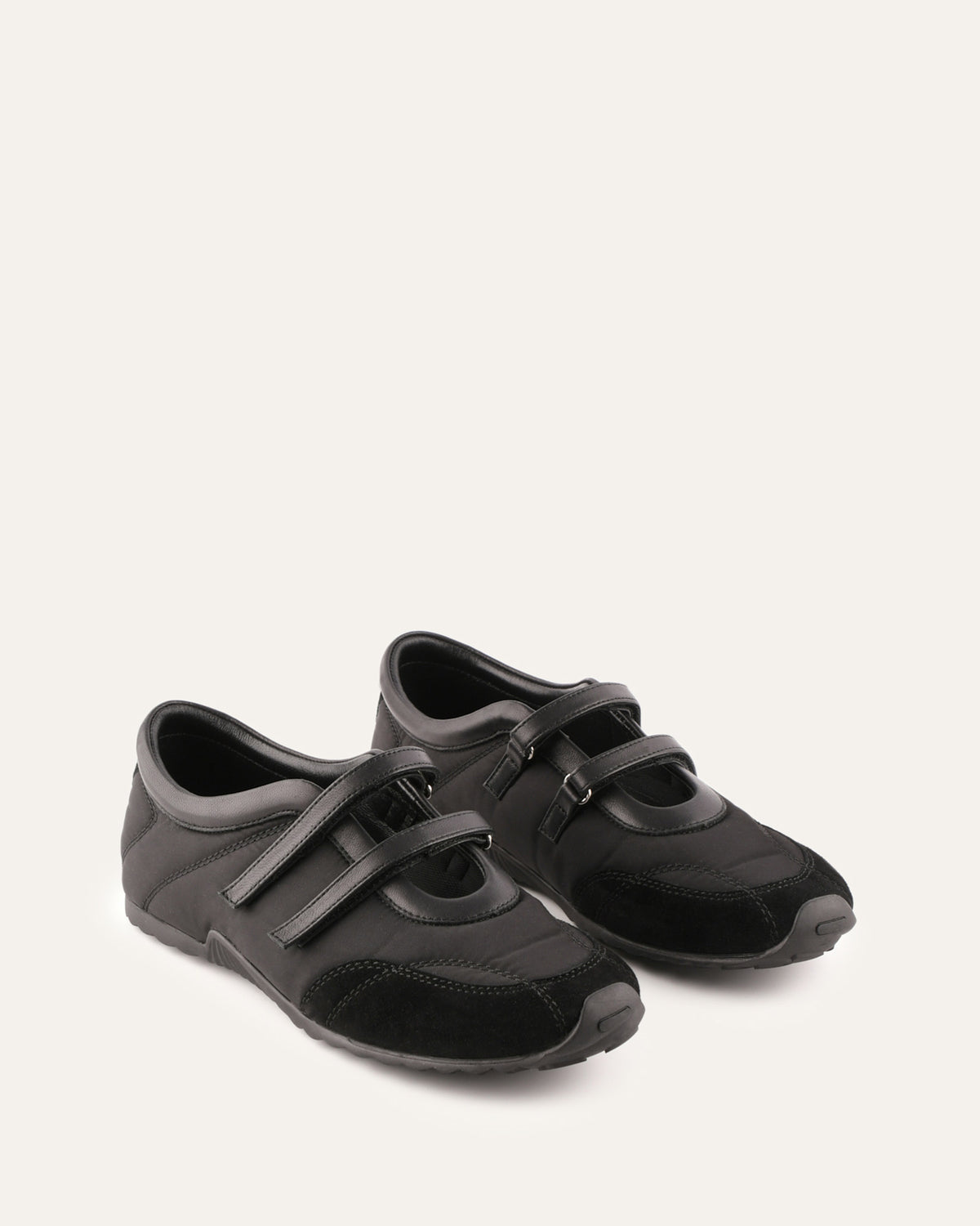 Pair of black shoes with velcro straps on a white background