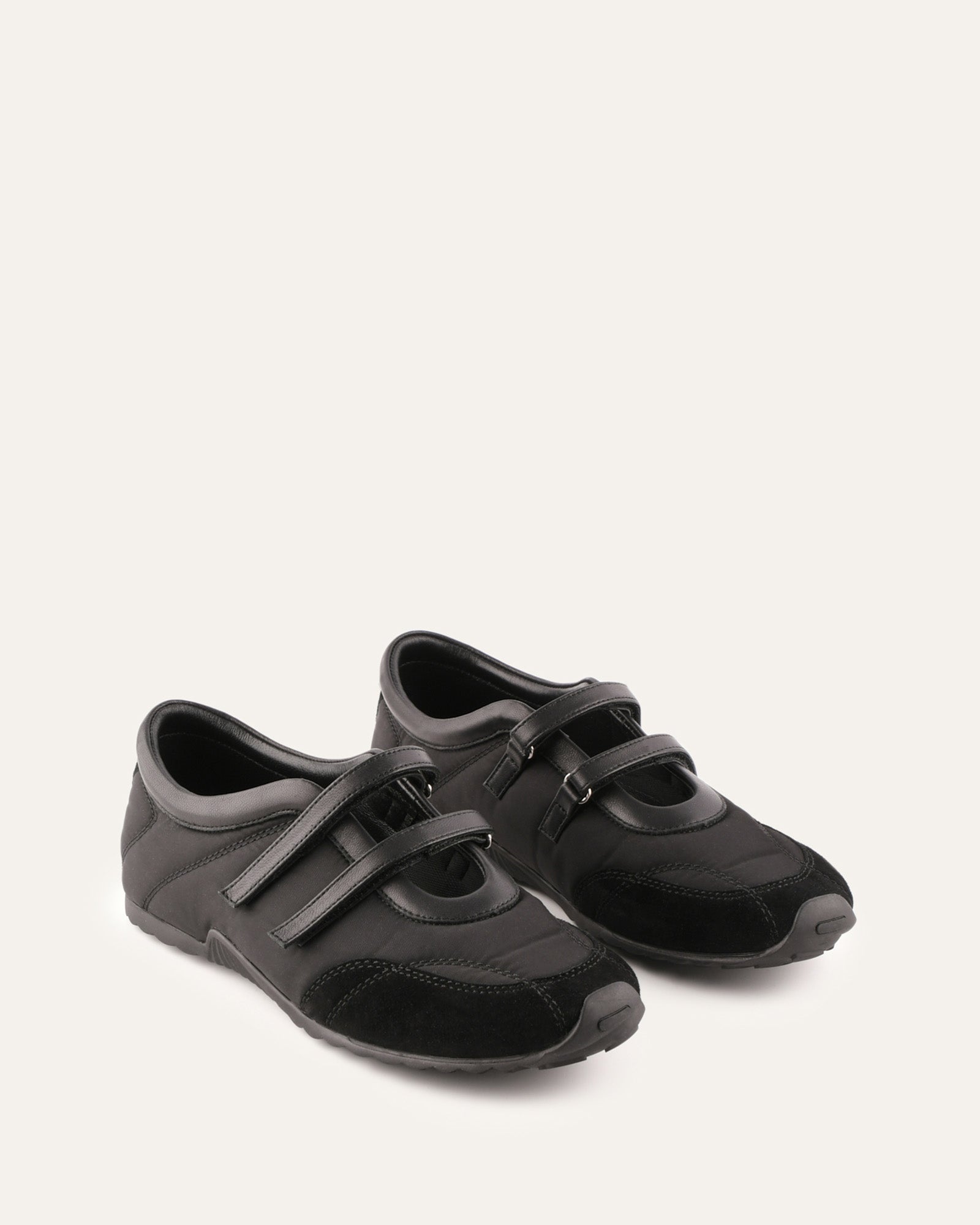 Black shoe with velcro straps on a white background
