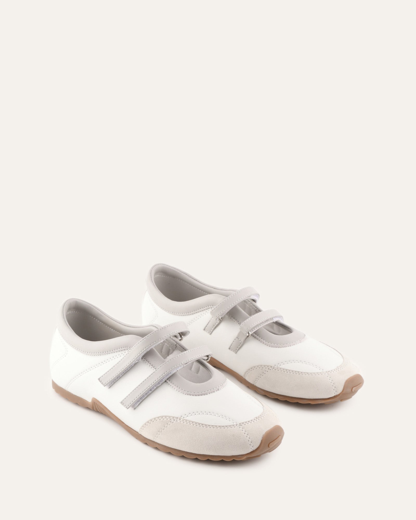 White shoe with a strap on a light gray background