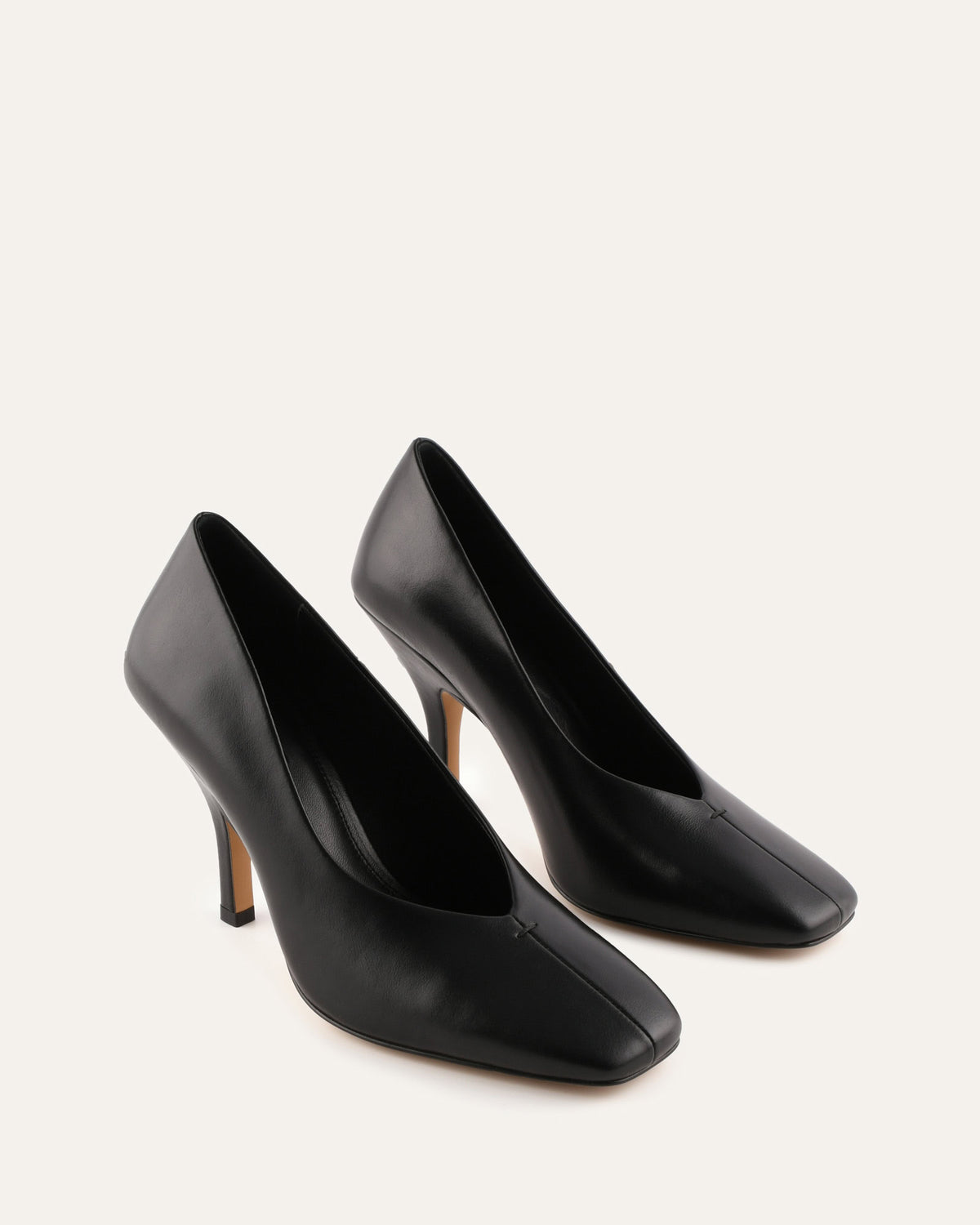 Pair of black high-heeled shoes on a white background