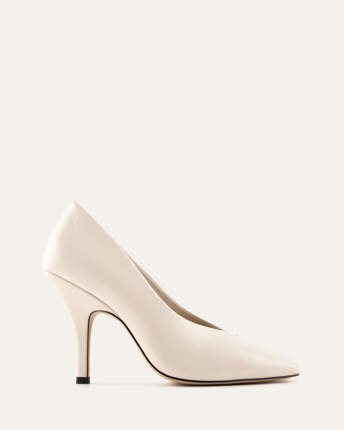 Beige high-heeled shoe on a light gray background