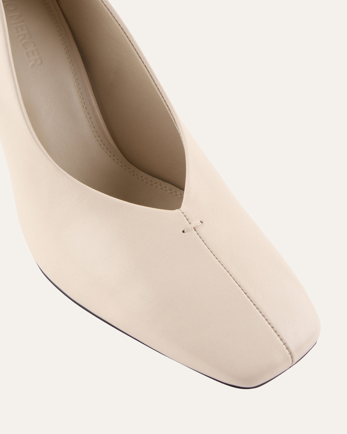 Beige high-heeled shoe on a white background