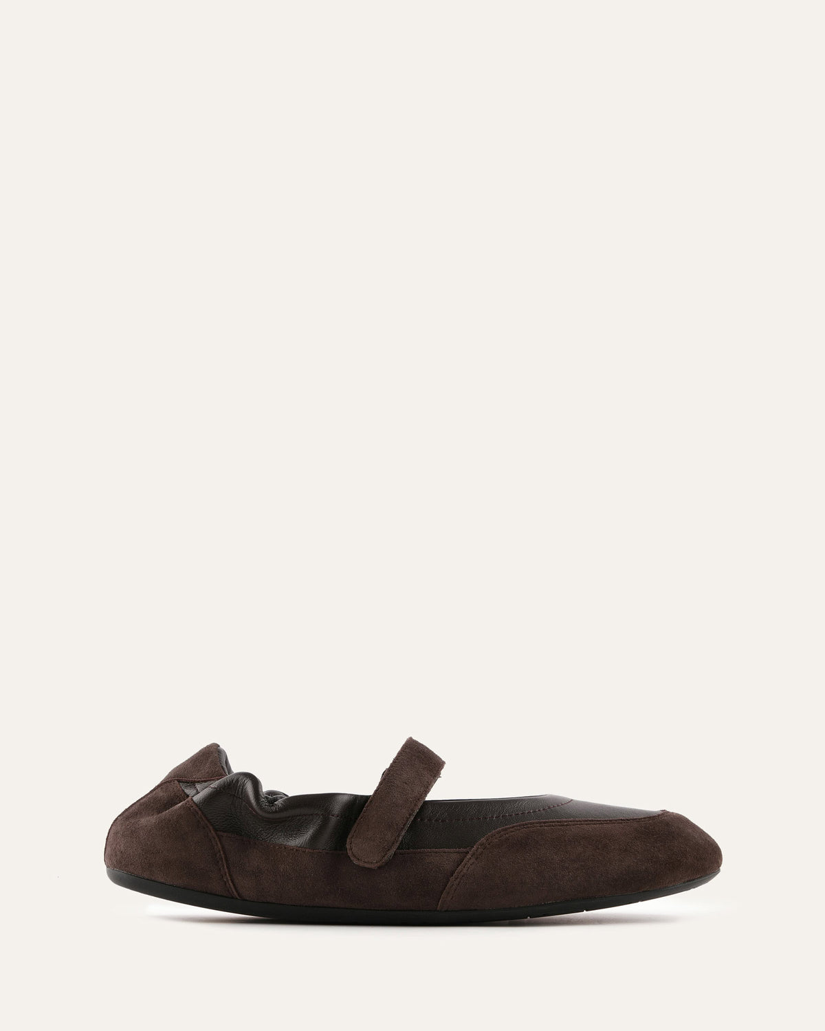Brown flat shoe with a strap on a white background