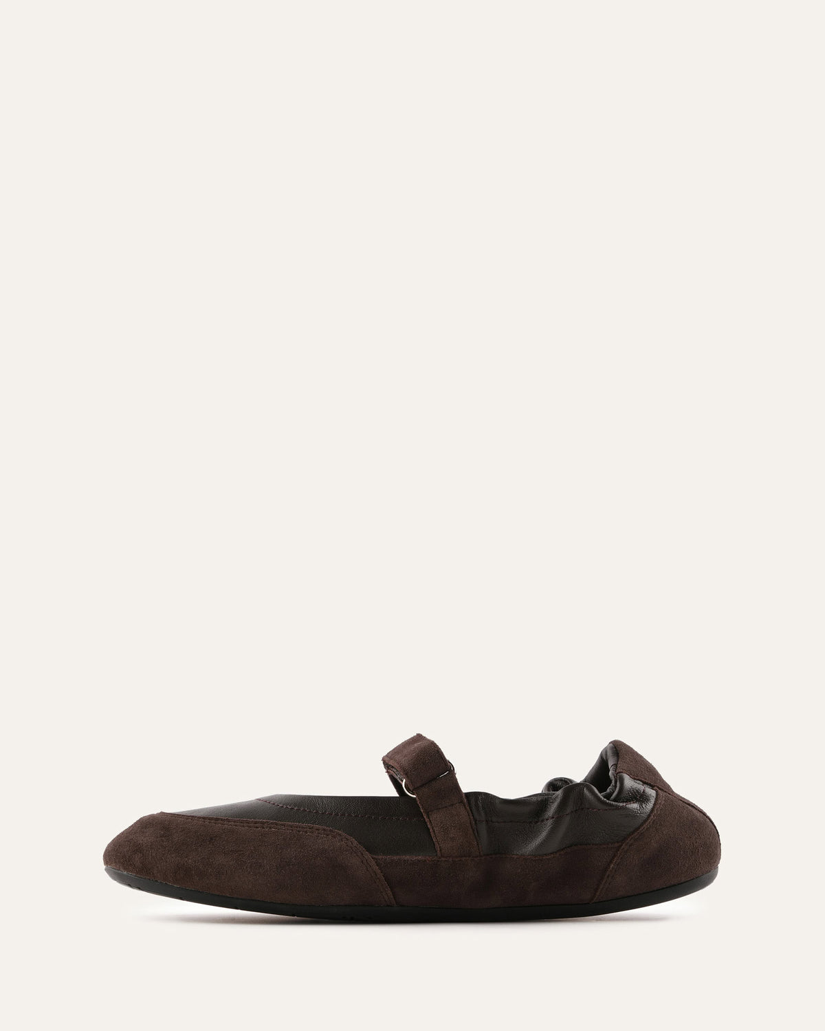 Brown flat shoe with a strap on a white background
