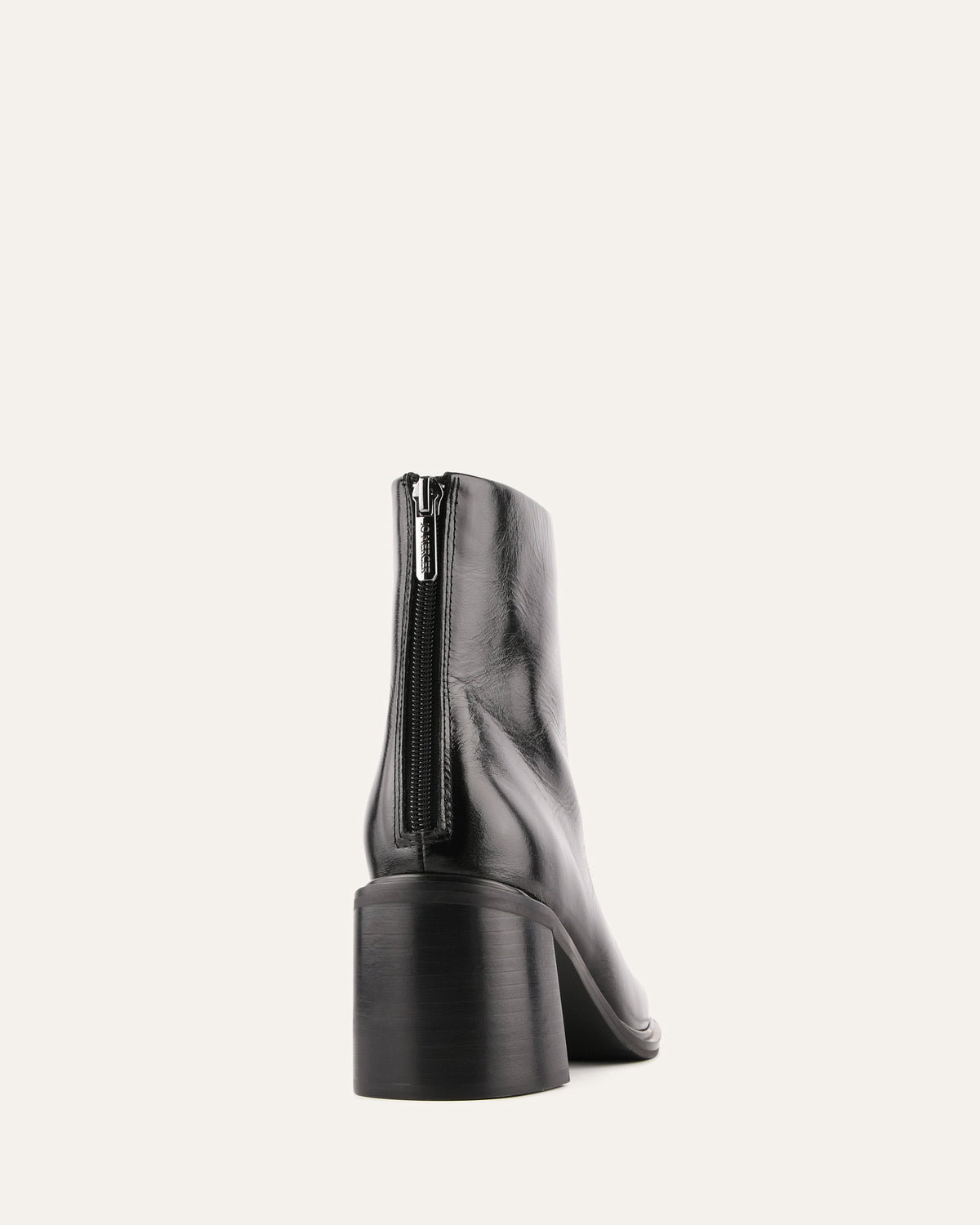 Black ankle boot with a zipper on a white background