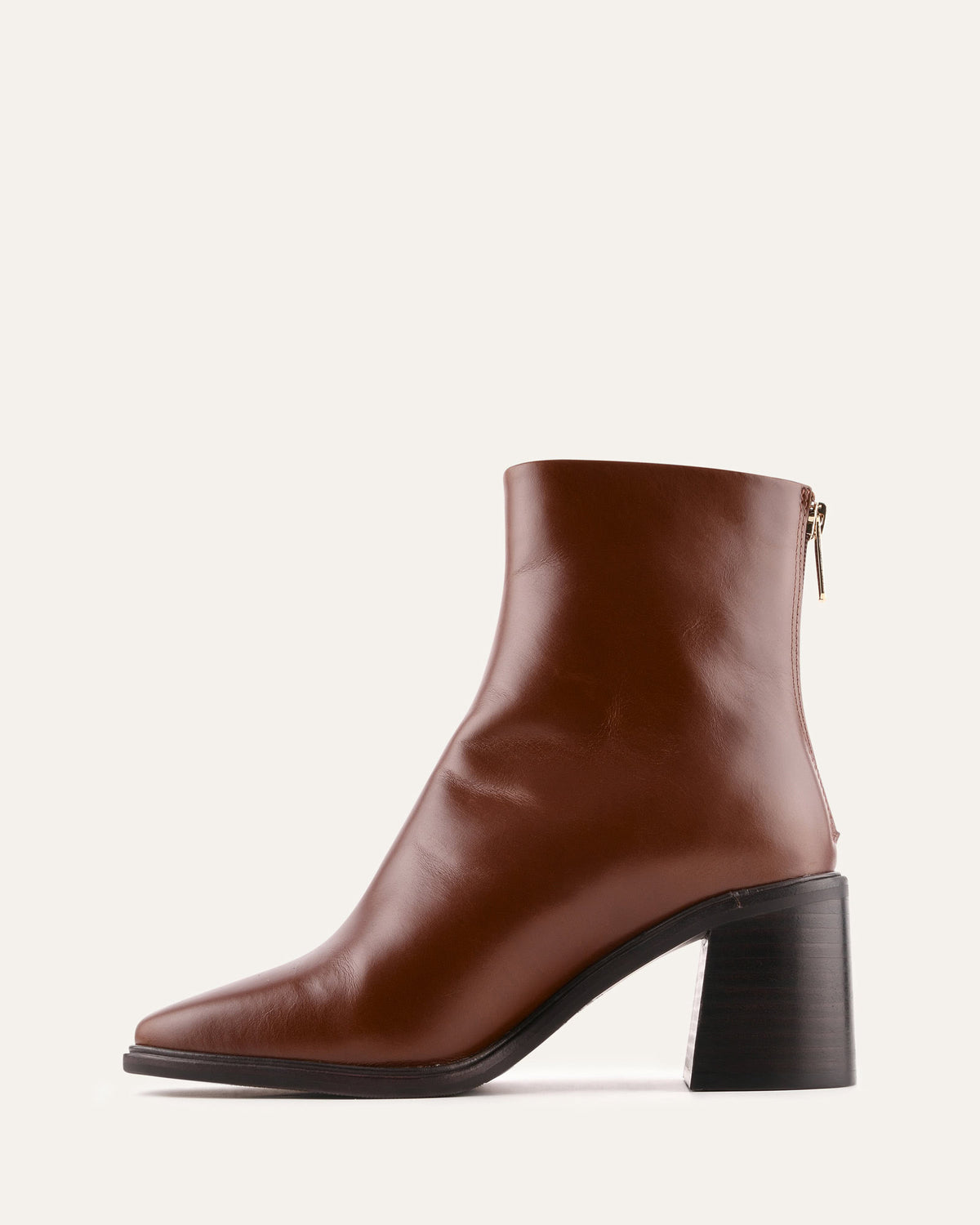 Brown ankle boot with a block heel on a light gray background