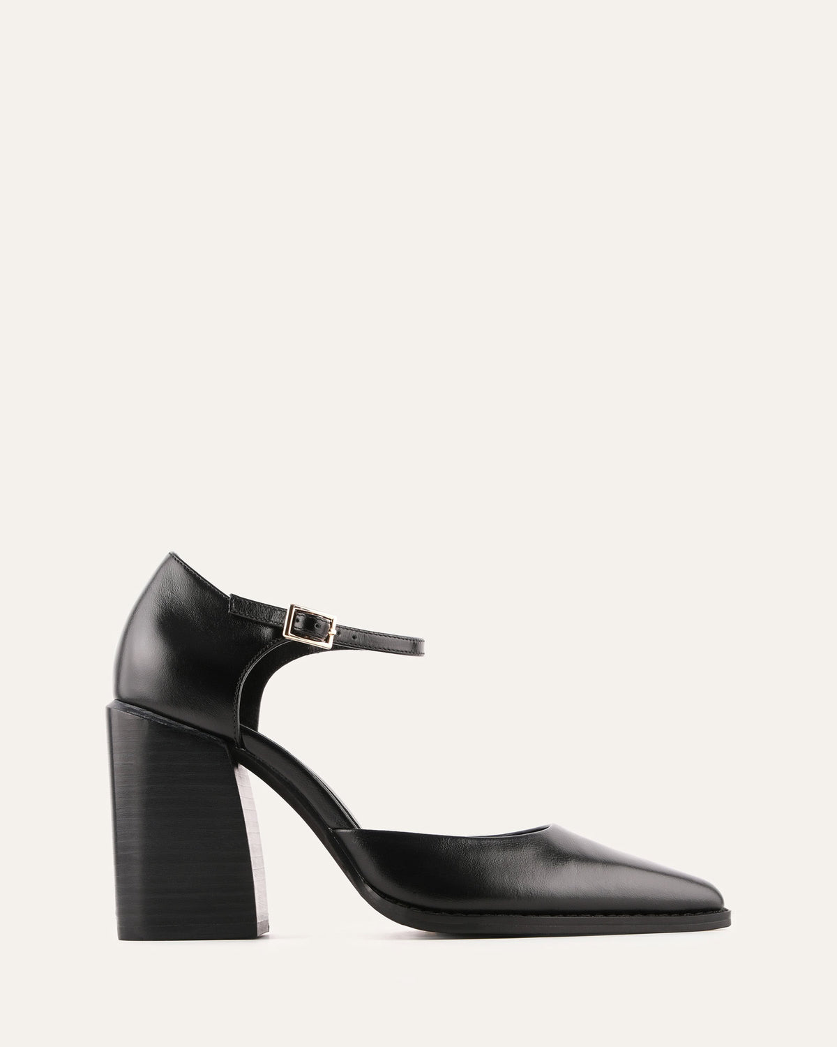 Black high-heeled shoe with a strap on a light gray background