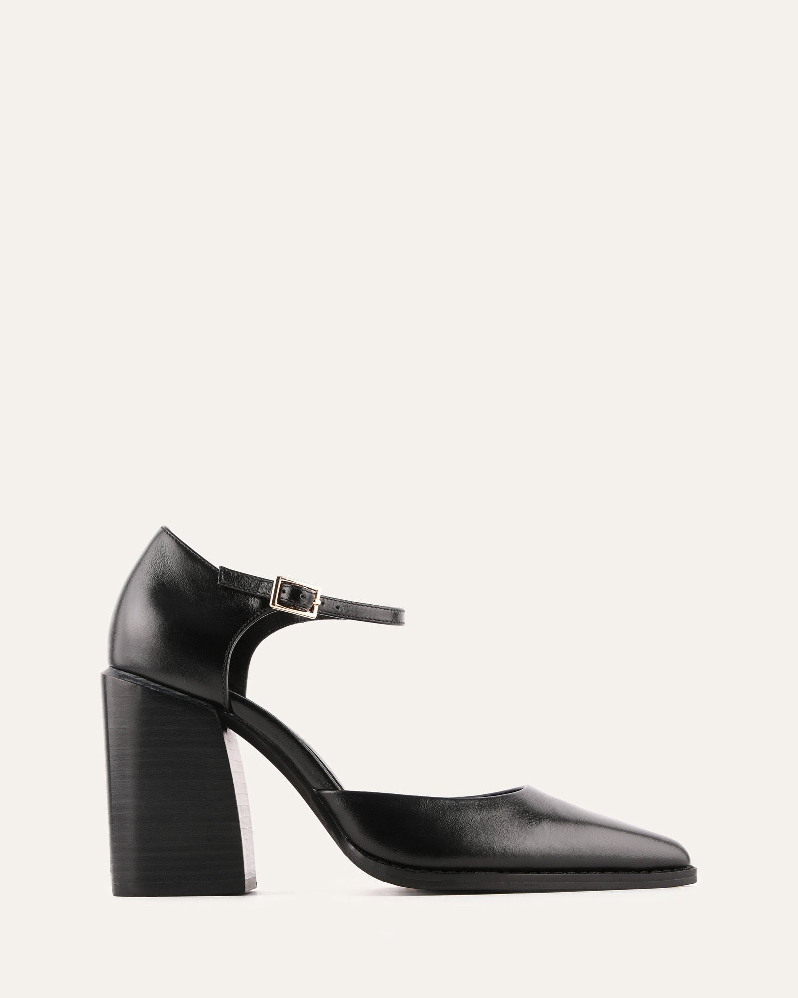 Black high-heeled shoe with a strap on a light gray background