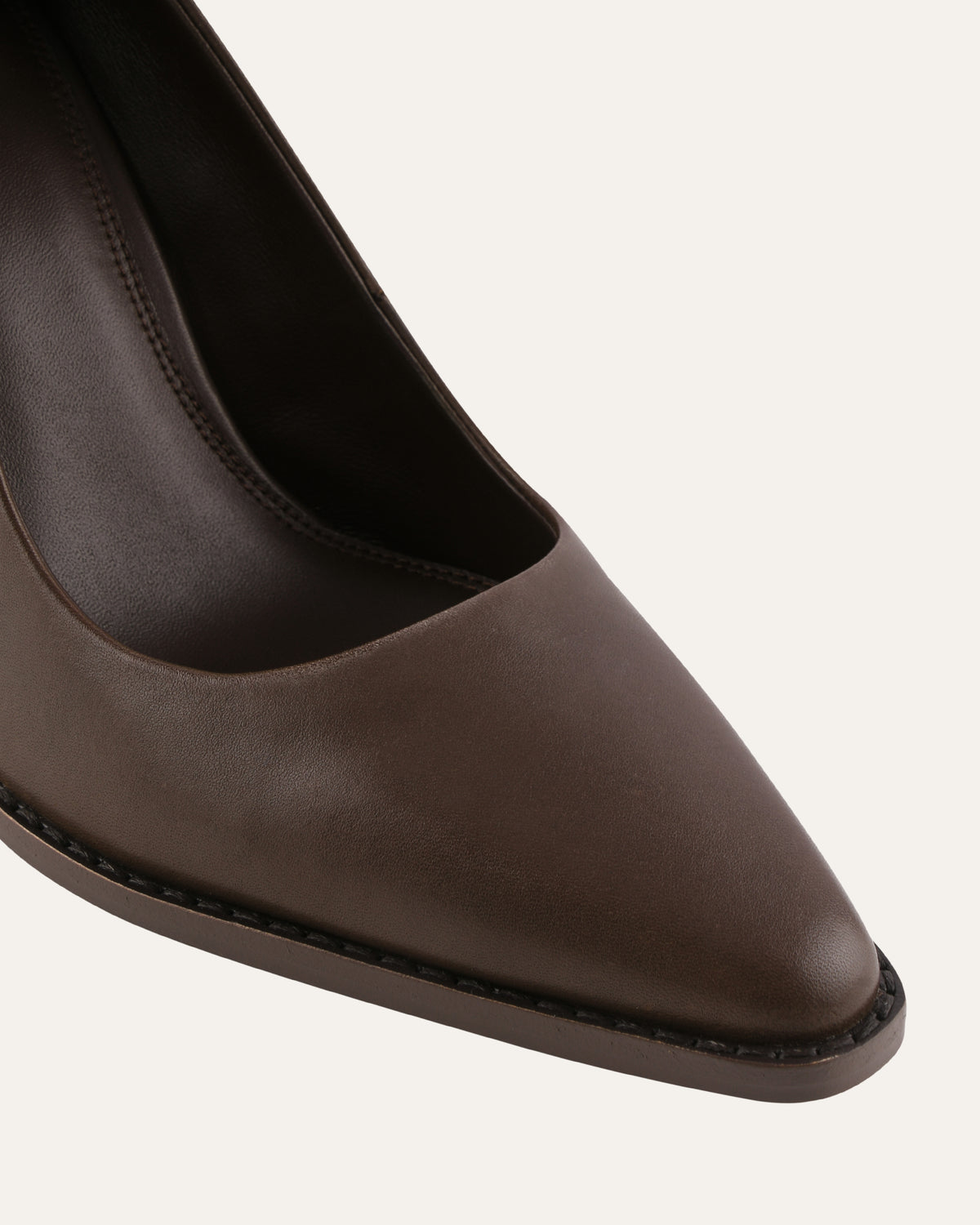 Brown leather pointed-toe shoe on a white background