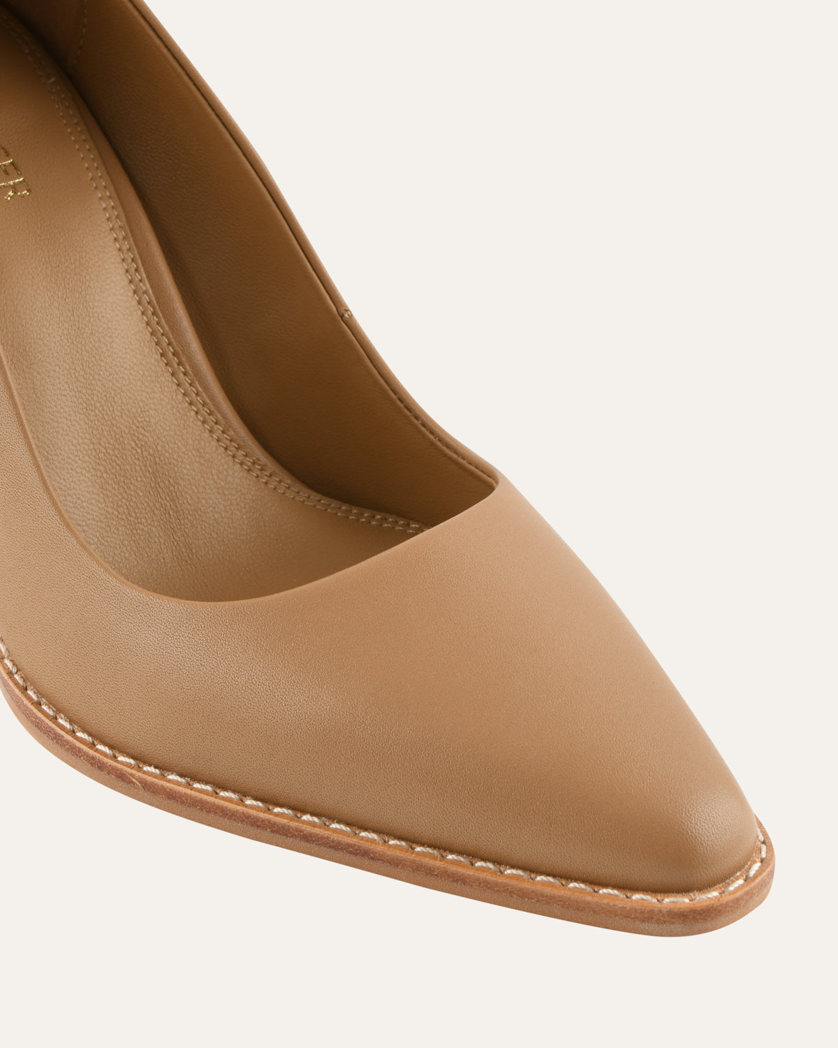 Tan high-heeled shoe on a white background