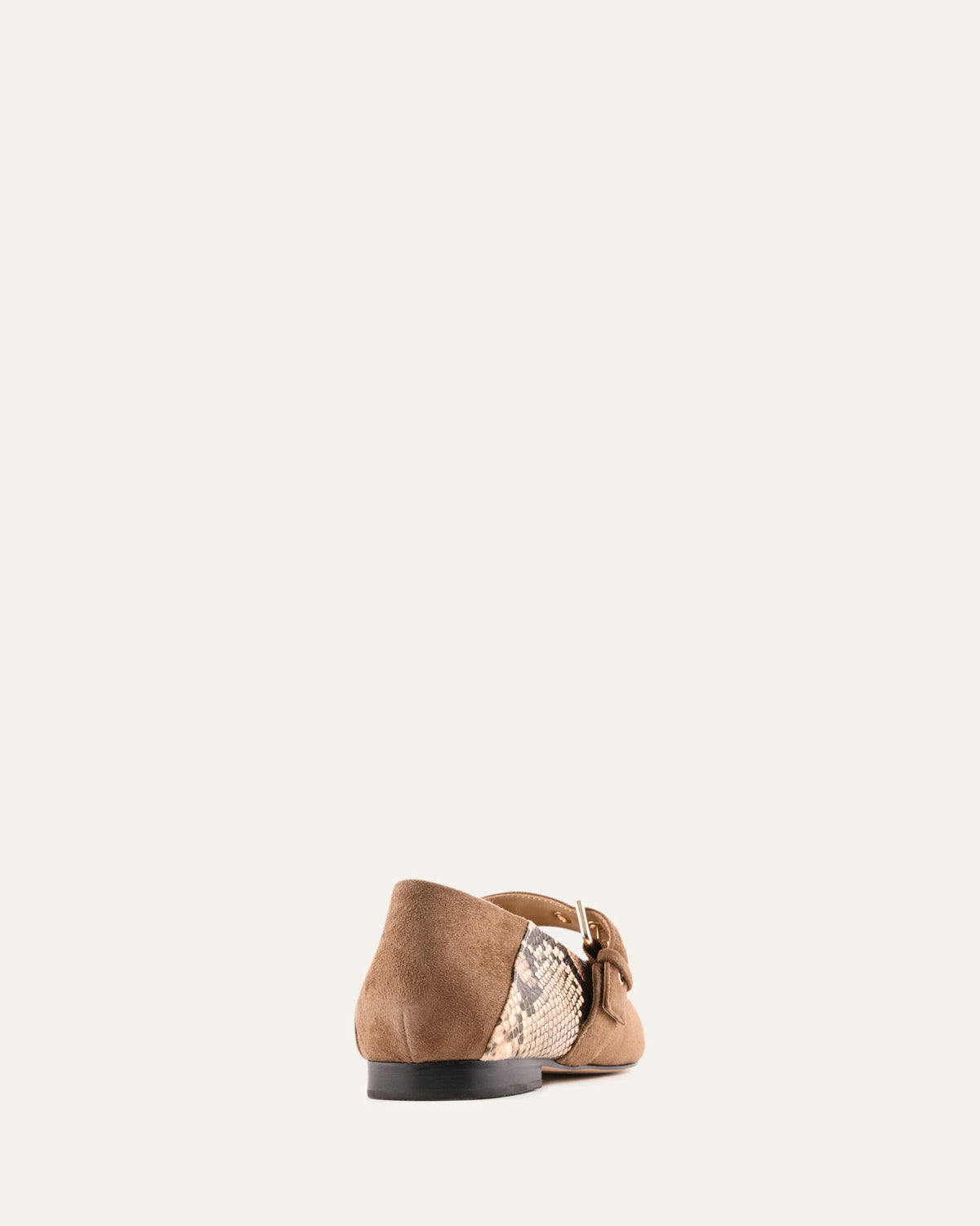 Brown flat shoe with a gold metallic sole on a white background