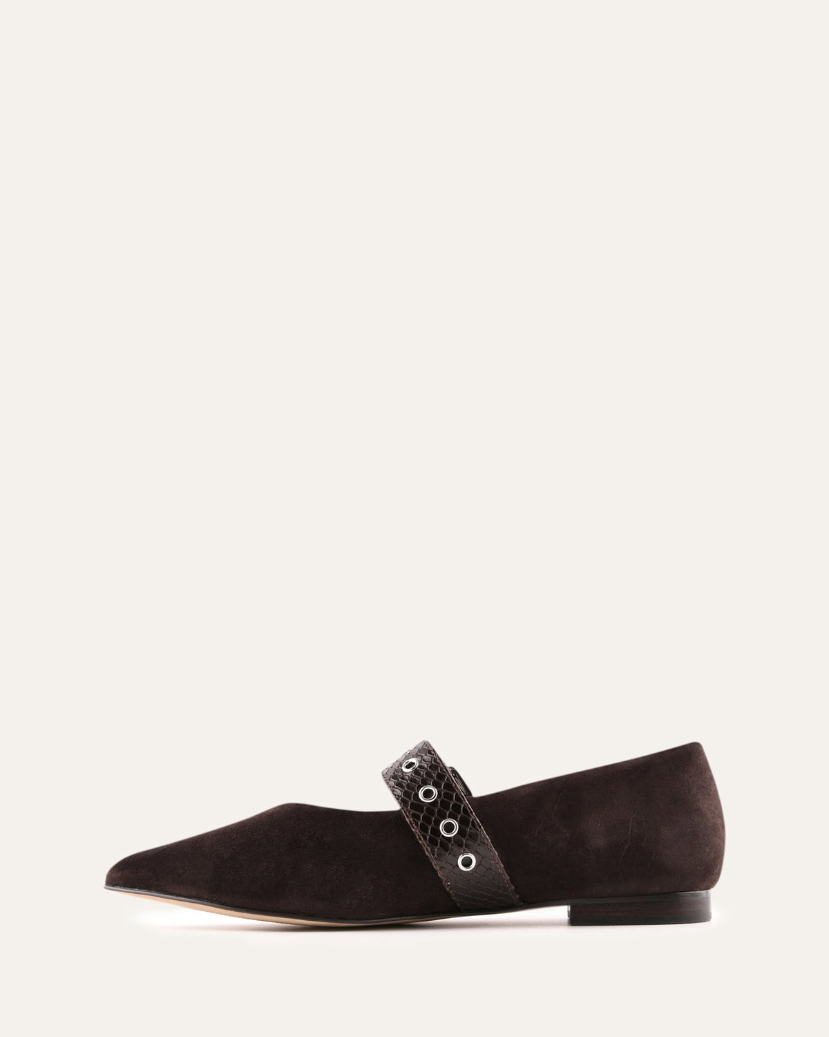 Black flat shoe with decorative strap on a white background