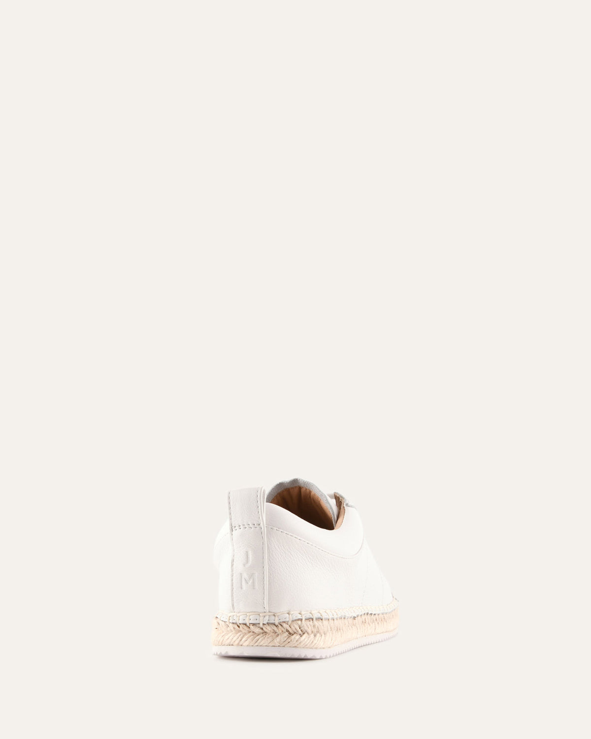 White sneaker with brown sole on a white background