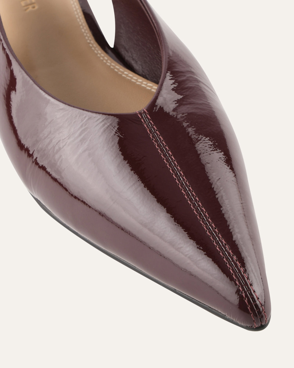Shiny brown pointed-toe shoe on a white background