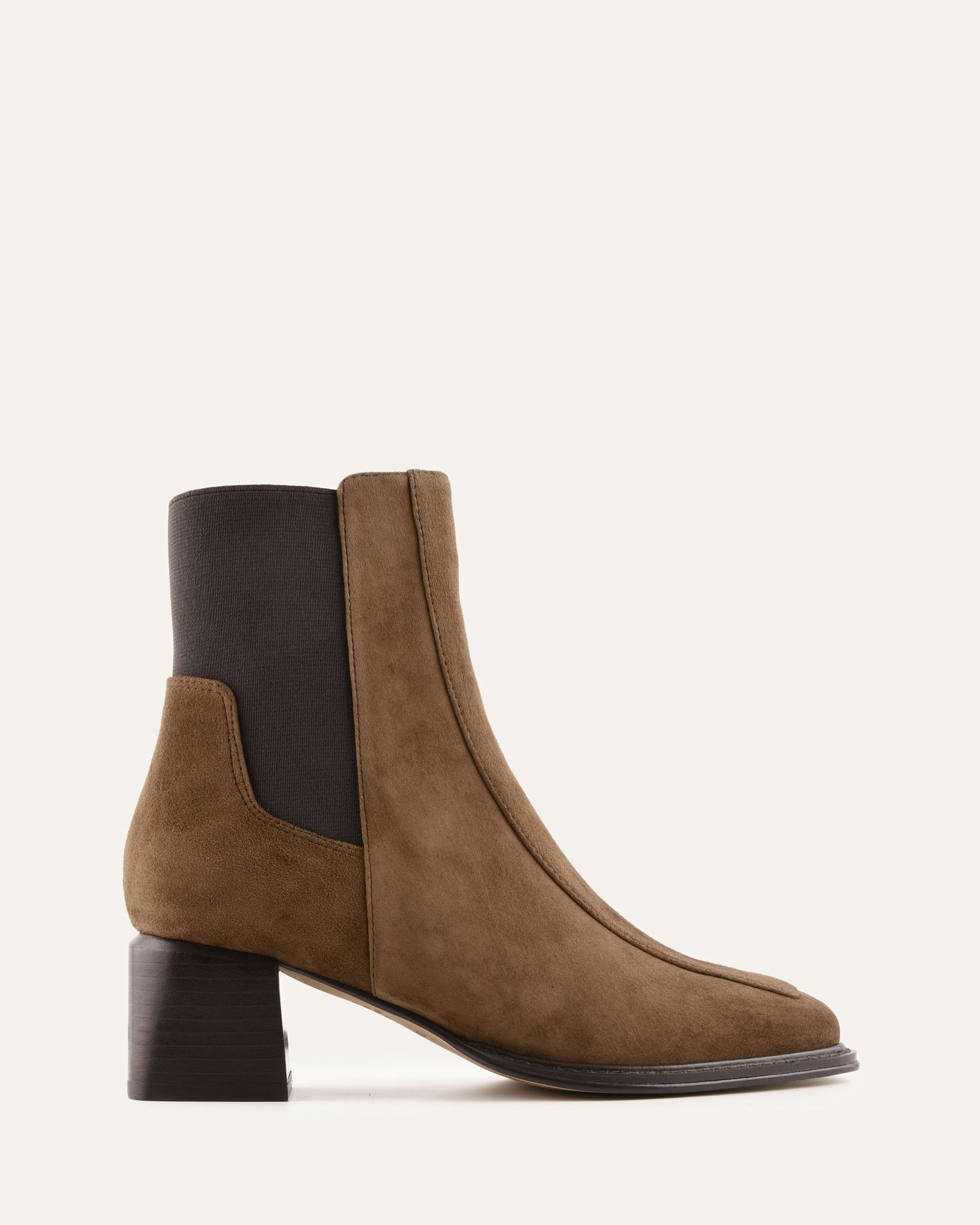 Brown ankle boot with black heel and lining on a white background