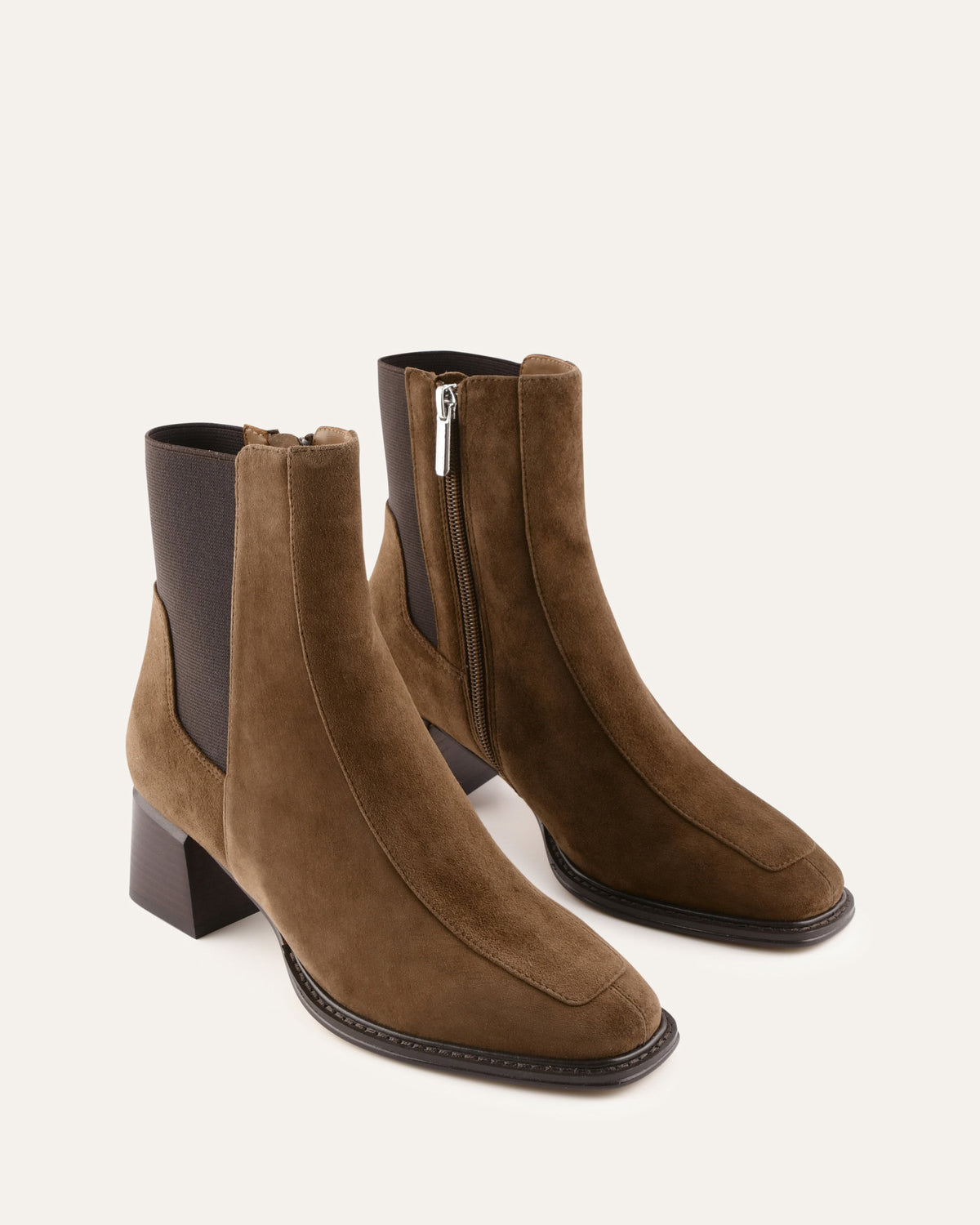 Pair of brown suede ankle boots with a block heel on a white background