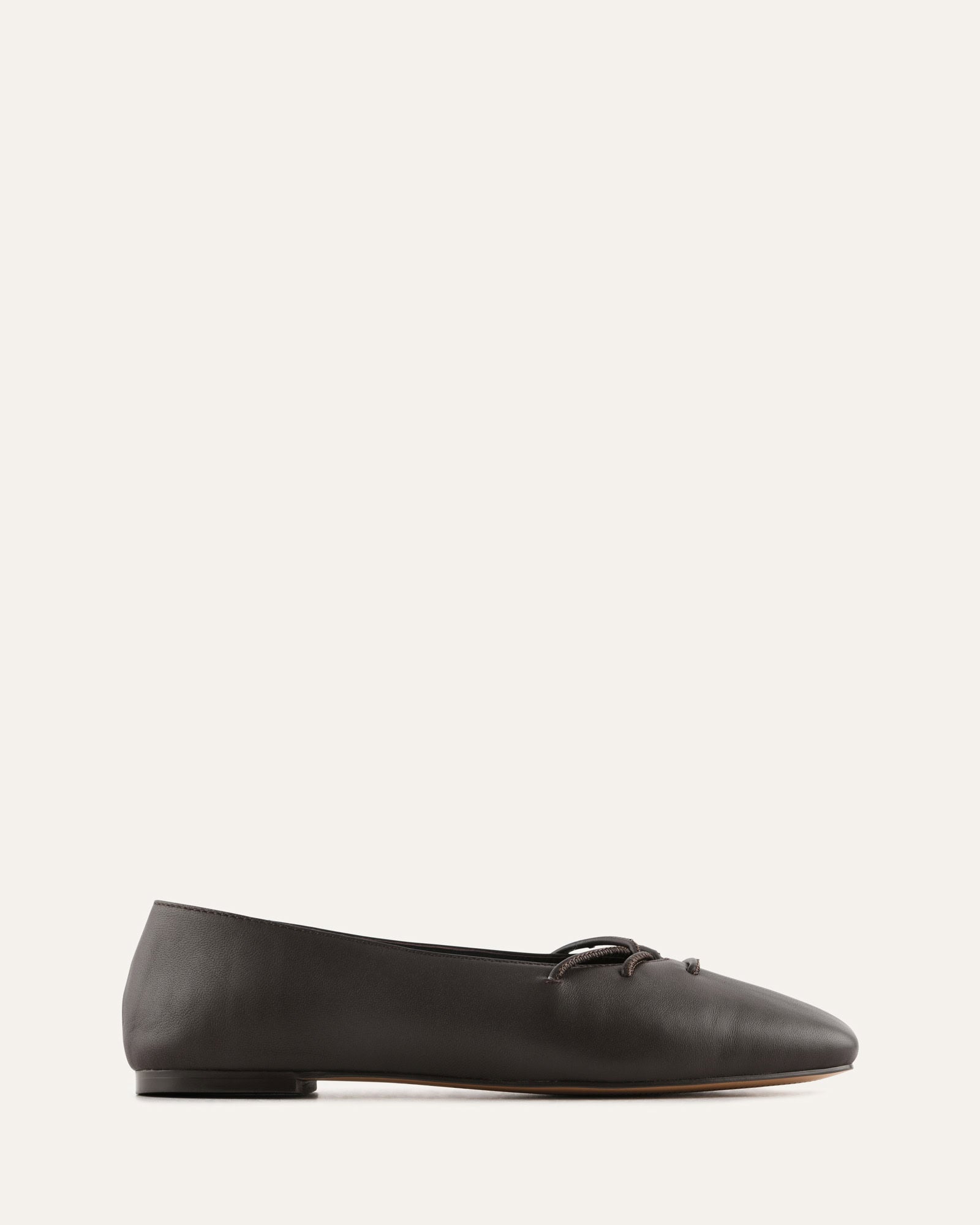 Choc leather flat shoe on a light gray background