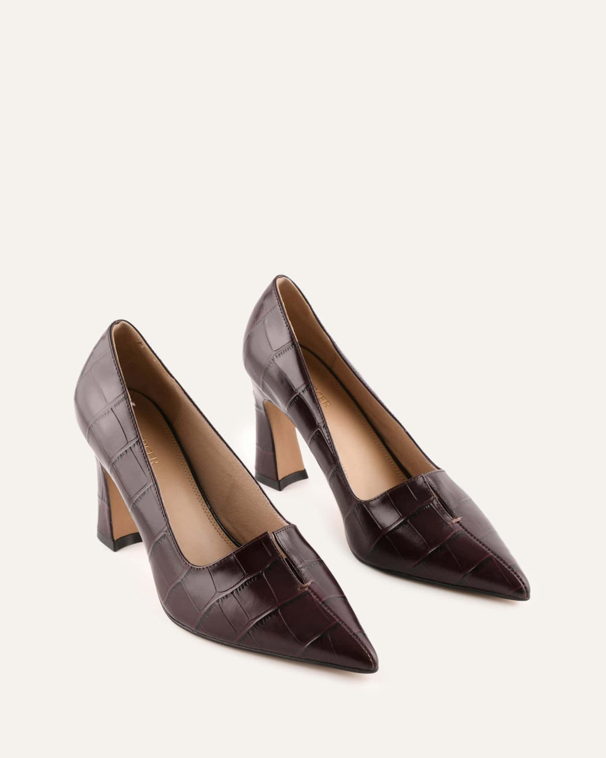 Pair of brown high-heeled shoes on a white background