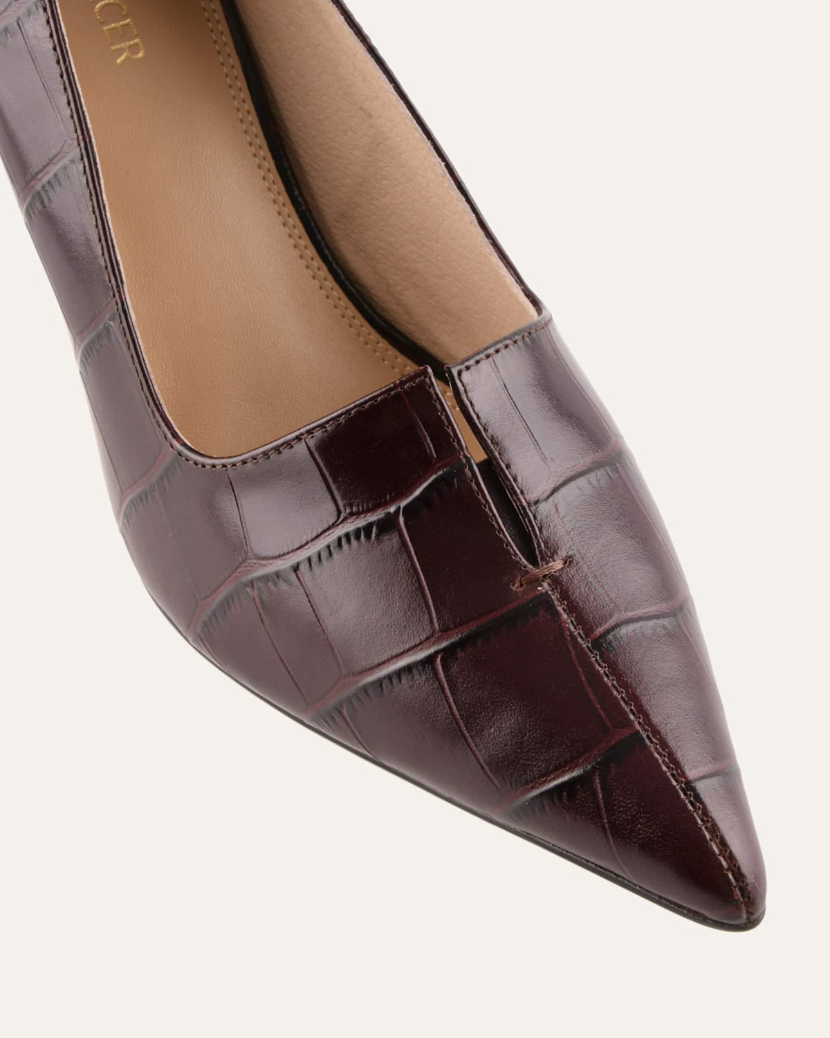 Brown pointed-toe shoe with crocodile texture on a white background