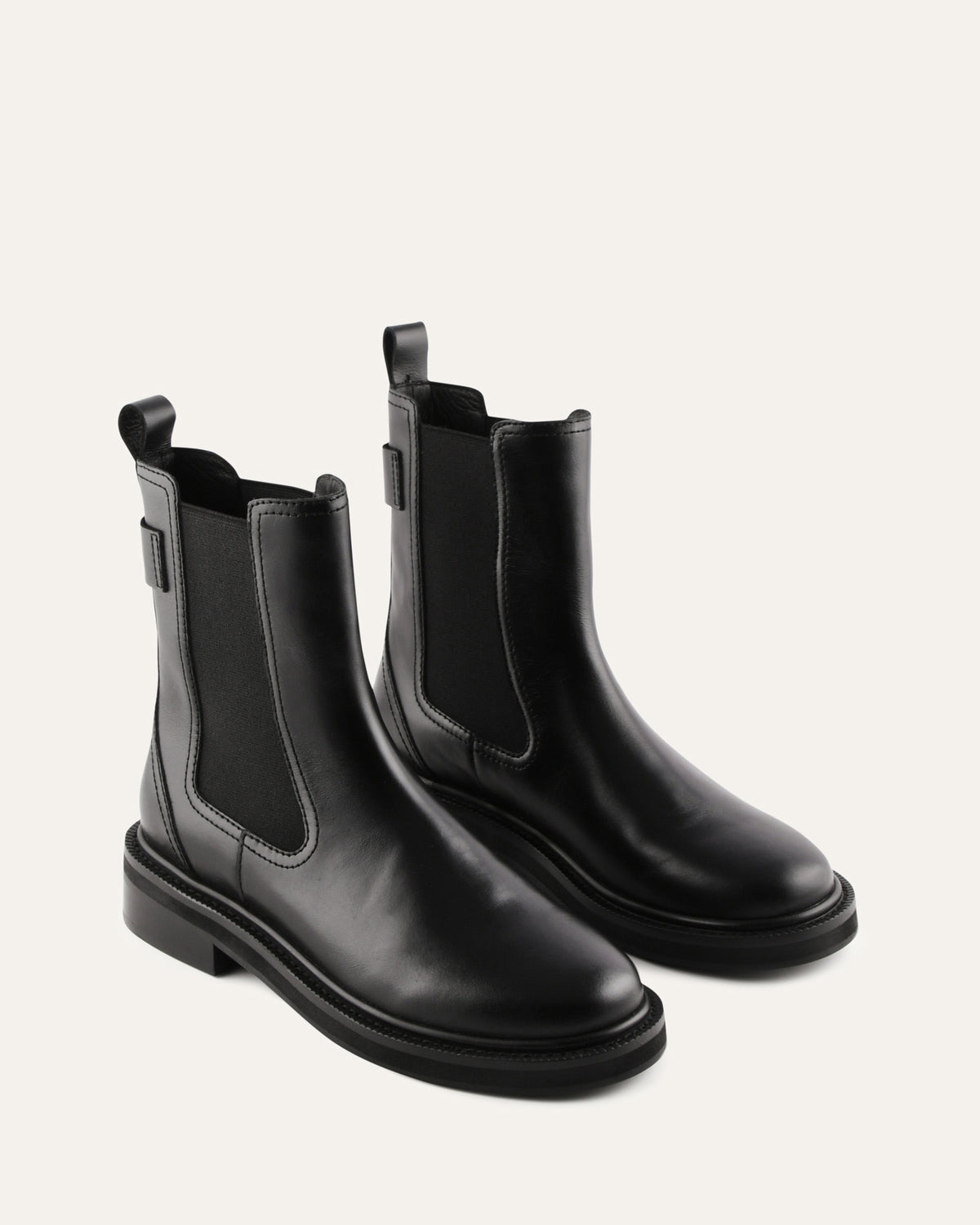 Pair of black leather Chelsea boots on a white background
