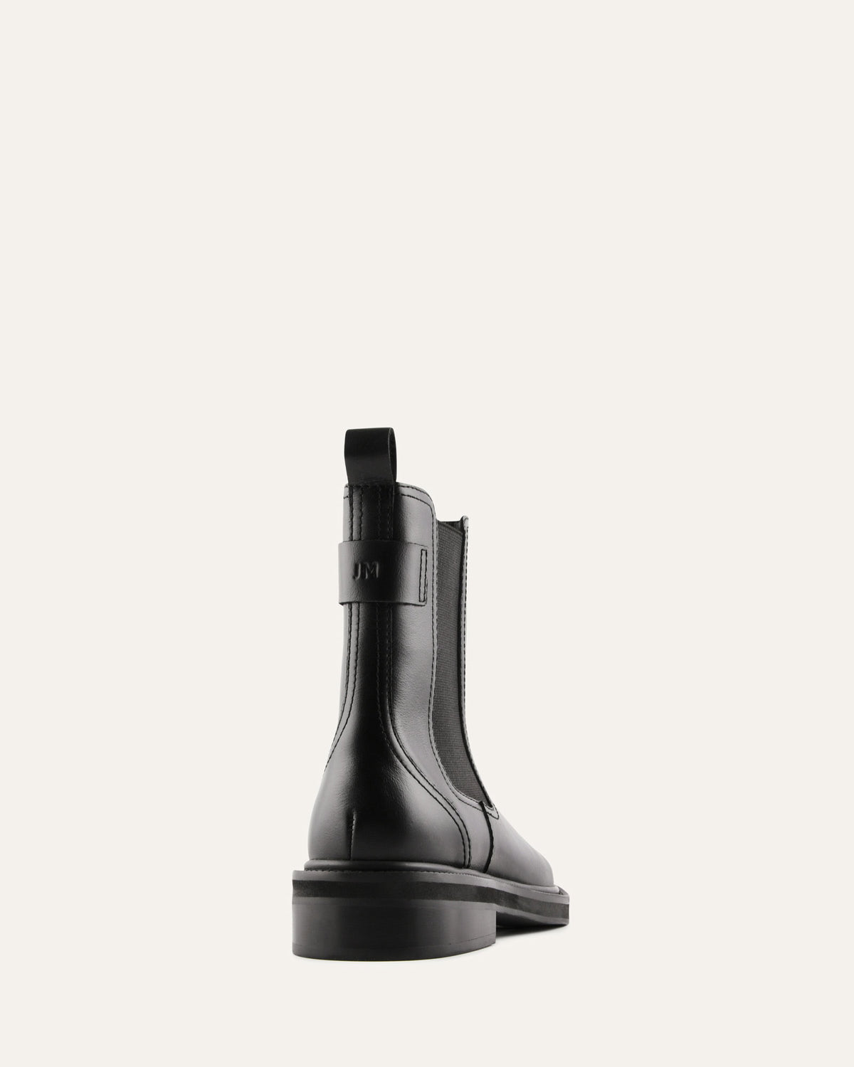 Black rain boot on a light gray background