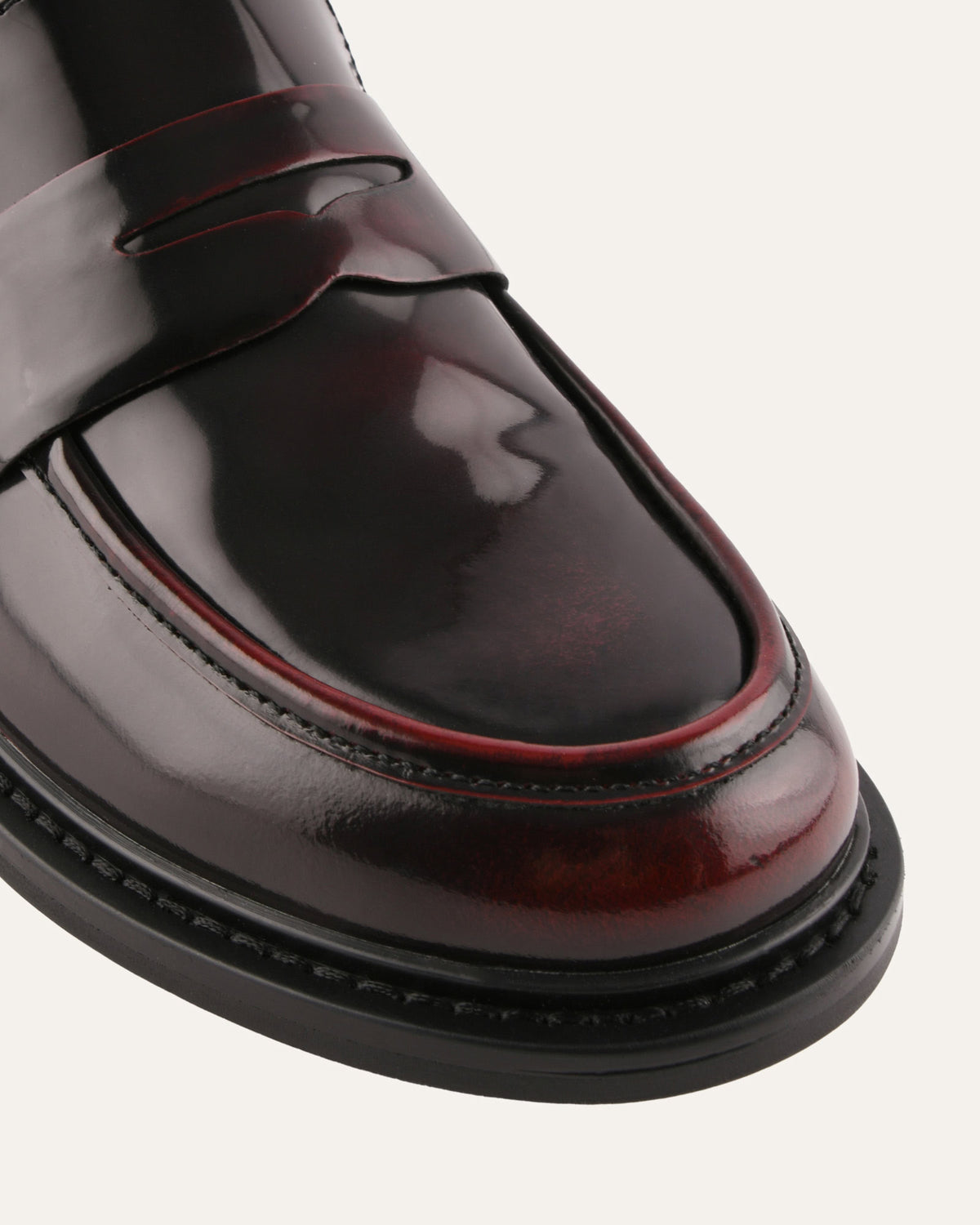 Shiny black loafer on a white background