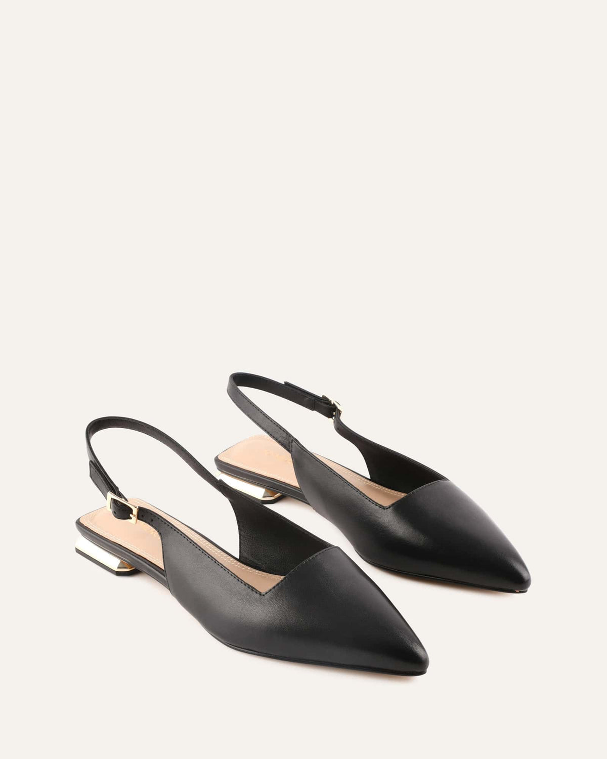 Black slingback shoes on a light gray background