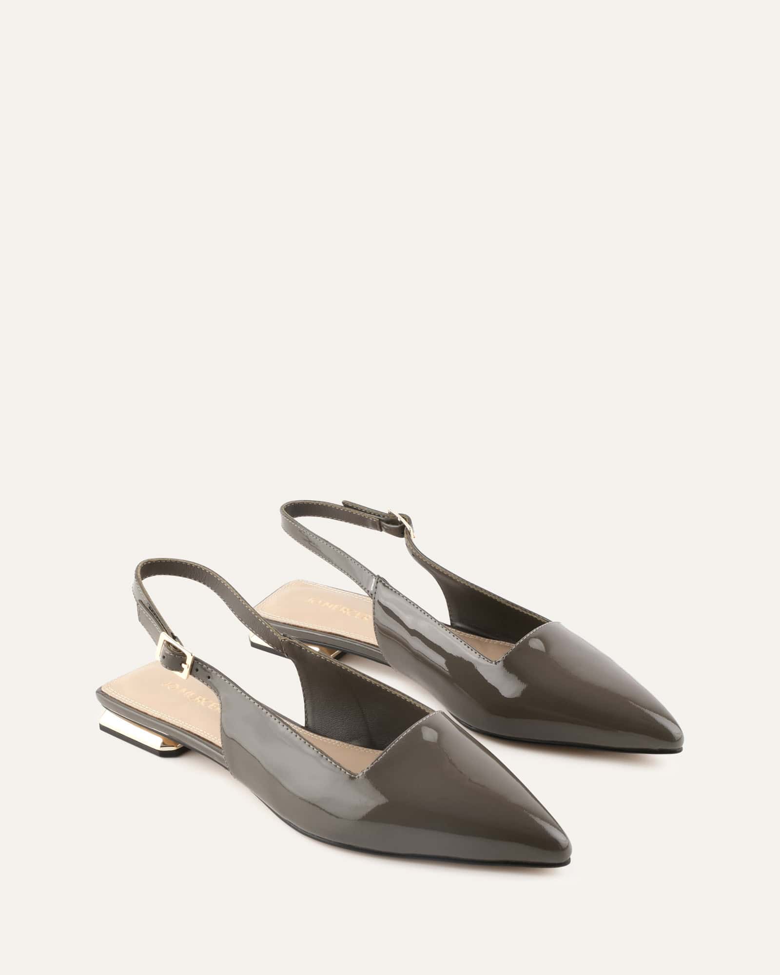 green patent leather slingback flat shoe on a white background