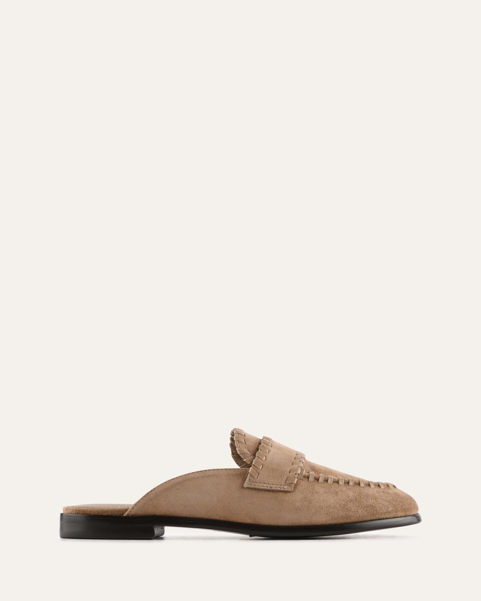 Brown suede loafer on a white background