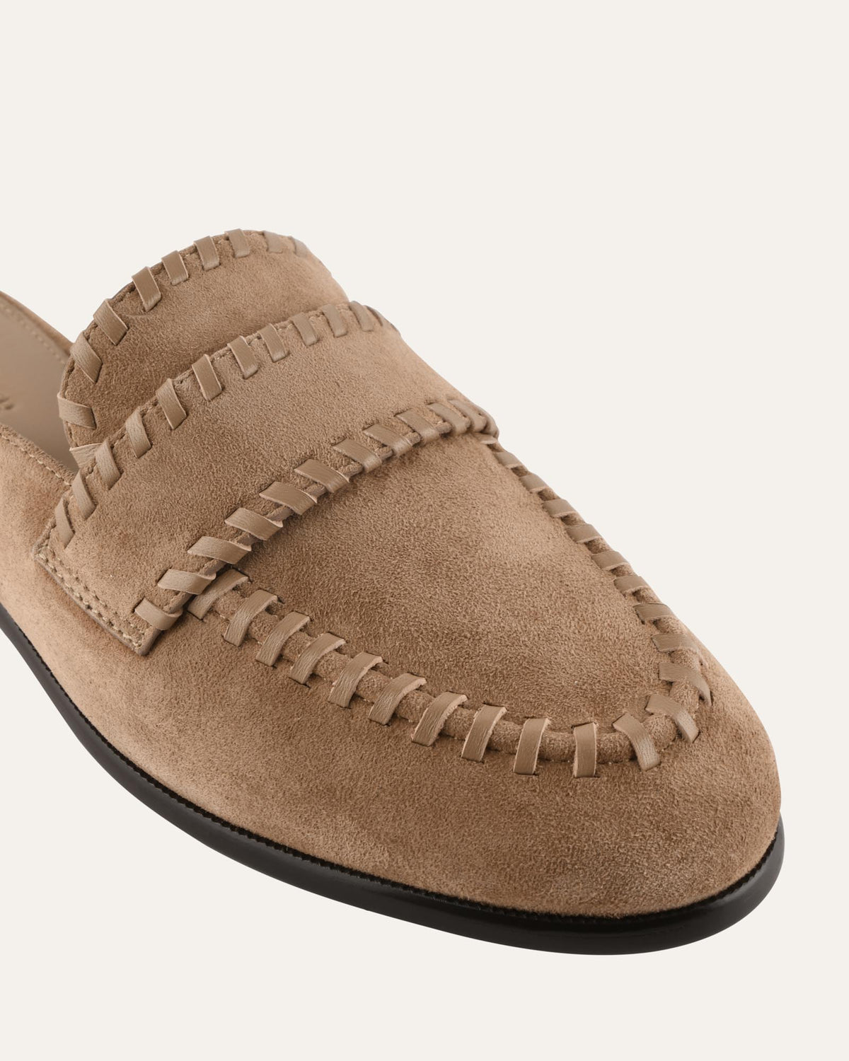 Tan suede loafer shoe on a white background