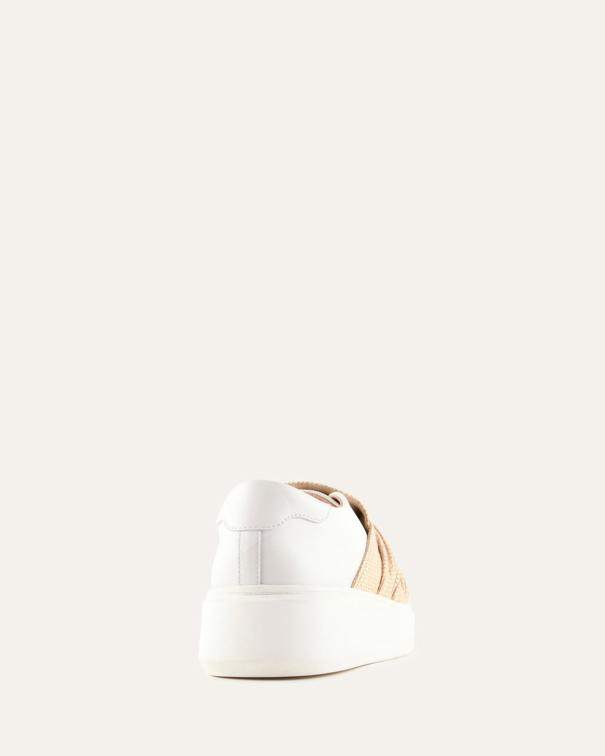 White shoe with gold accents on a light beige background