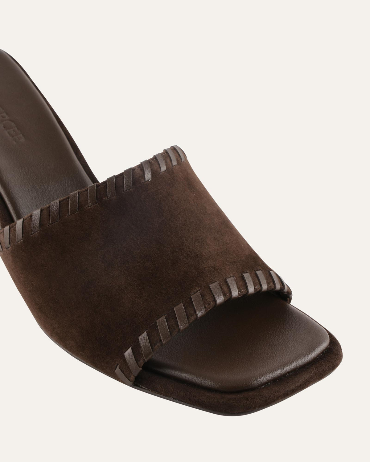 Brown sandal with decorative straps on a white background