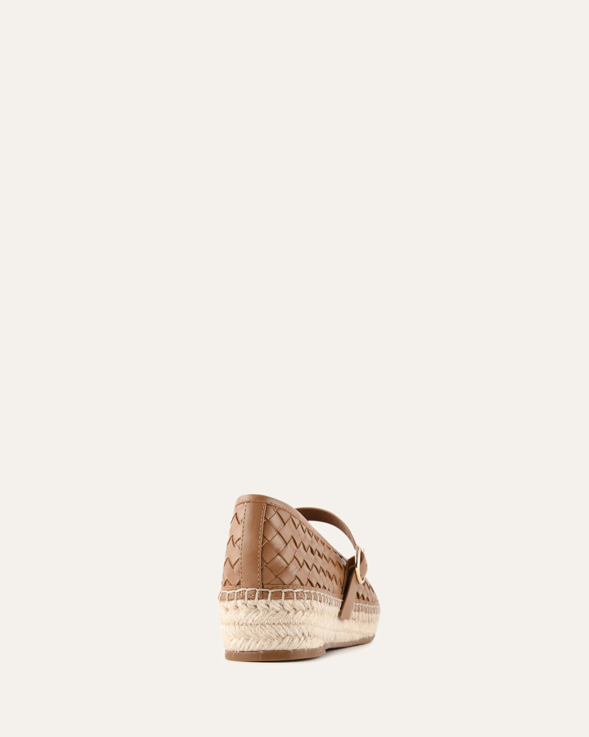 Brown woven espadrille shoe on a white background