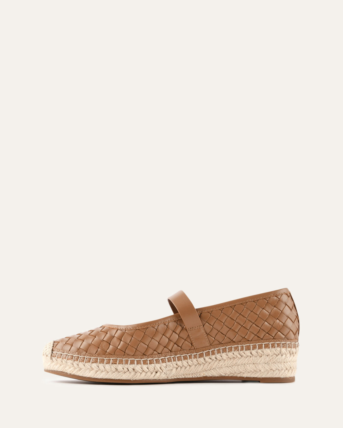 Brown woven espadrille shoe on a white background