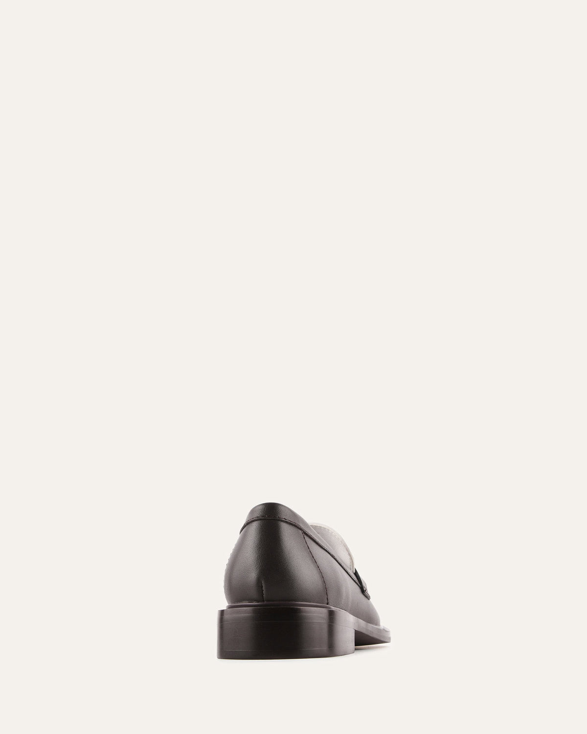 Black leather shoe on a light gray background